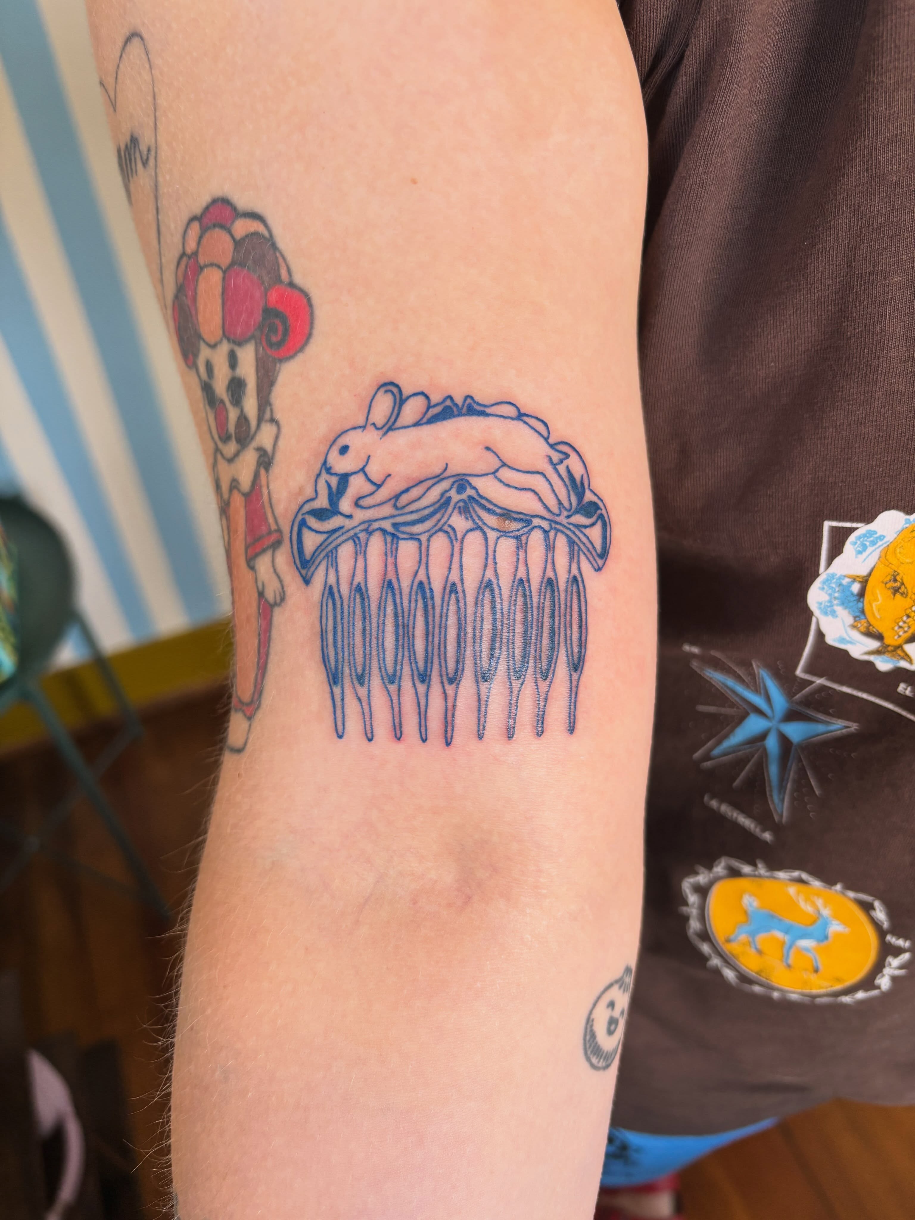 Jellyfish and rabbit dotwork tattoo on the forearm by Ashley Ellerman