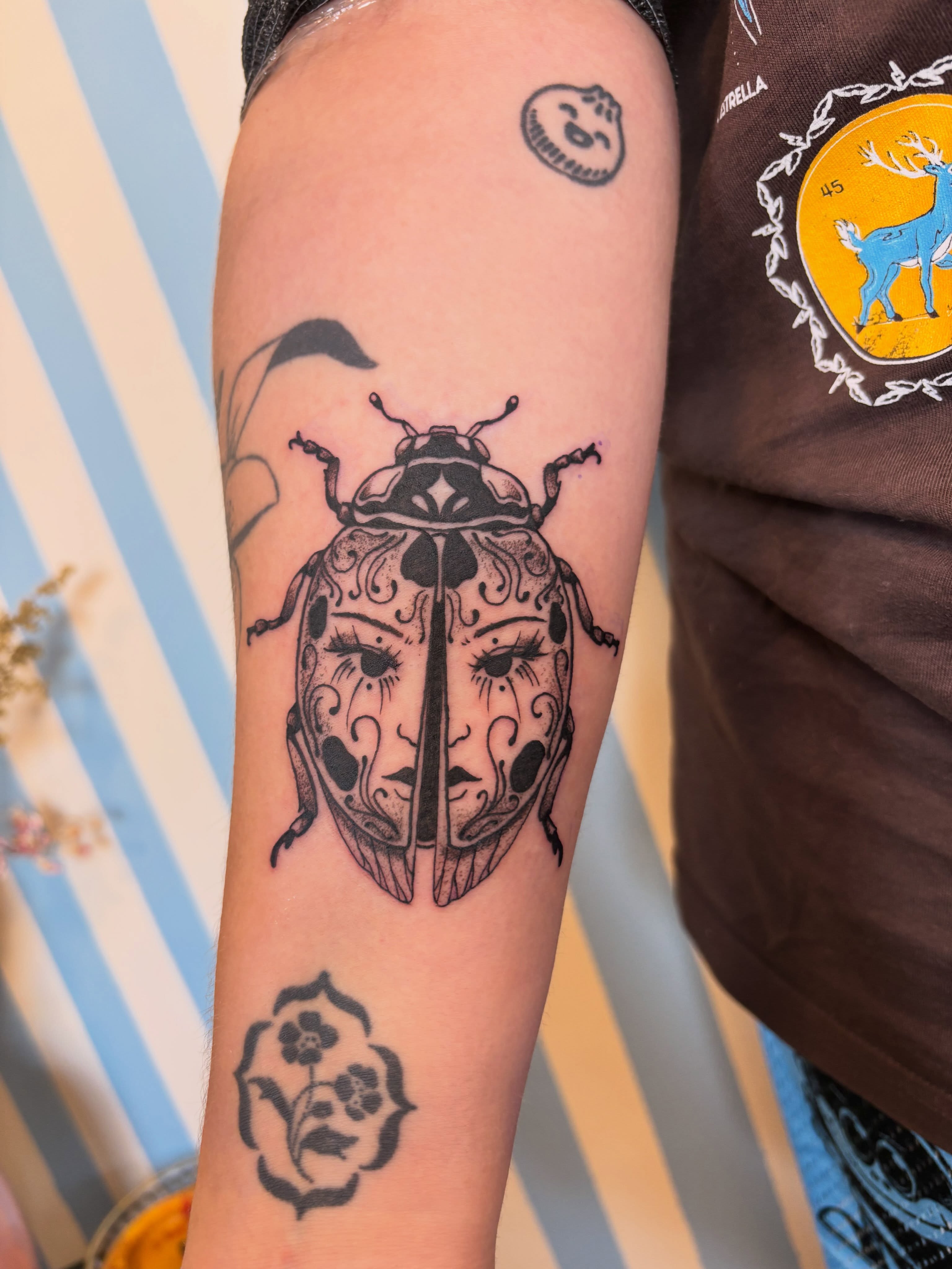 Beetle black and grey tattoo on the forearm by Ashley Ellerman