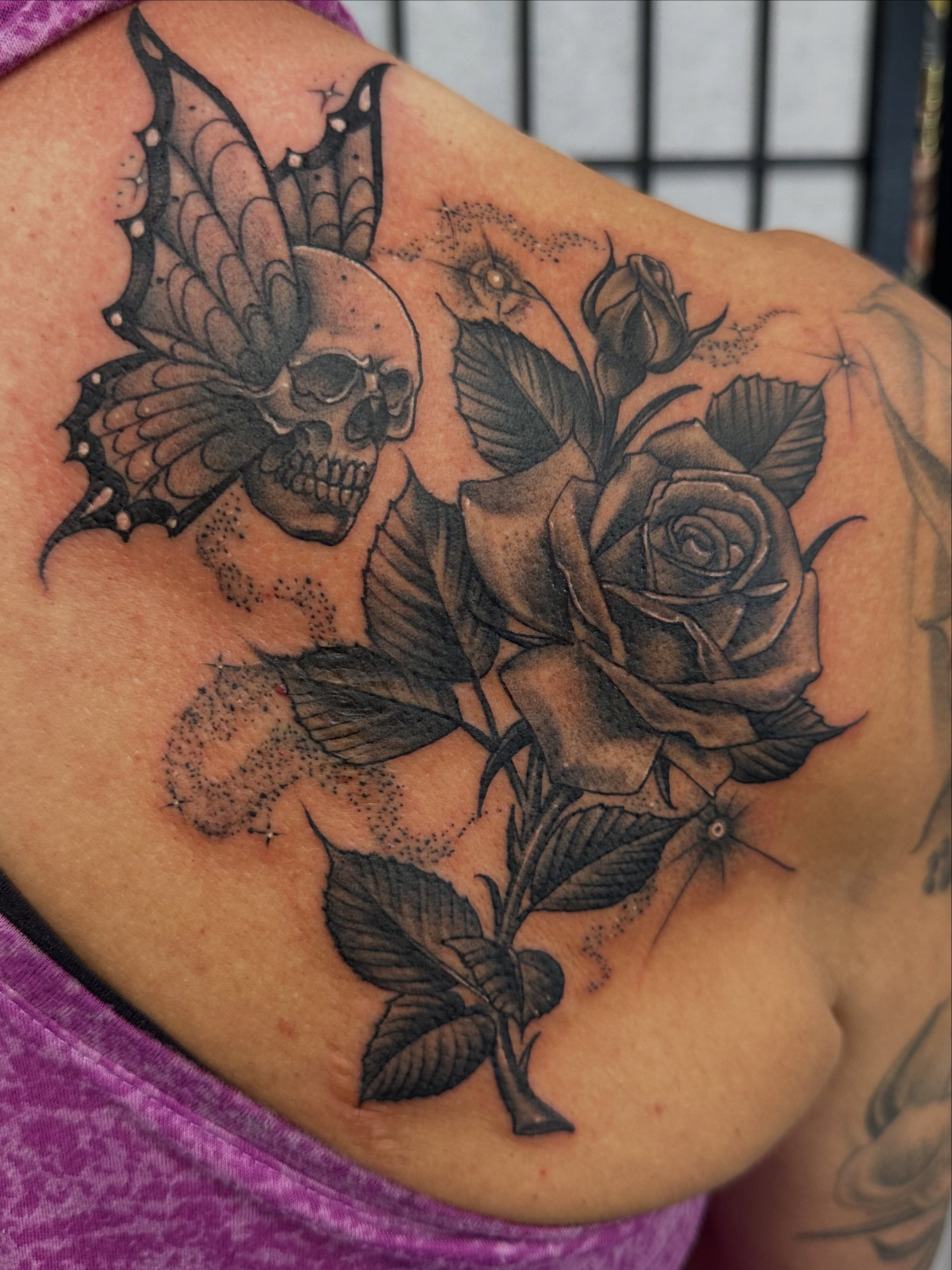 Skull and roses dotwork tattoo on the shoulder by Stevie O'Dell