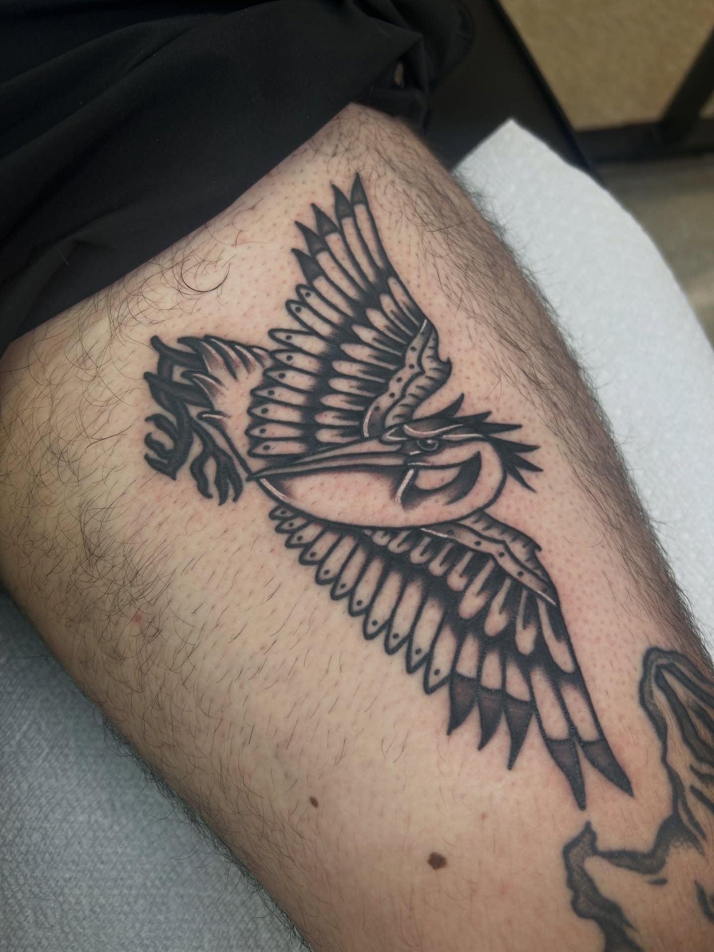 Heron black and grey tattoo on the thigh by Dylan James
