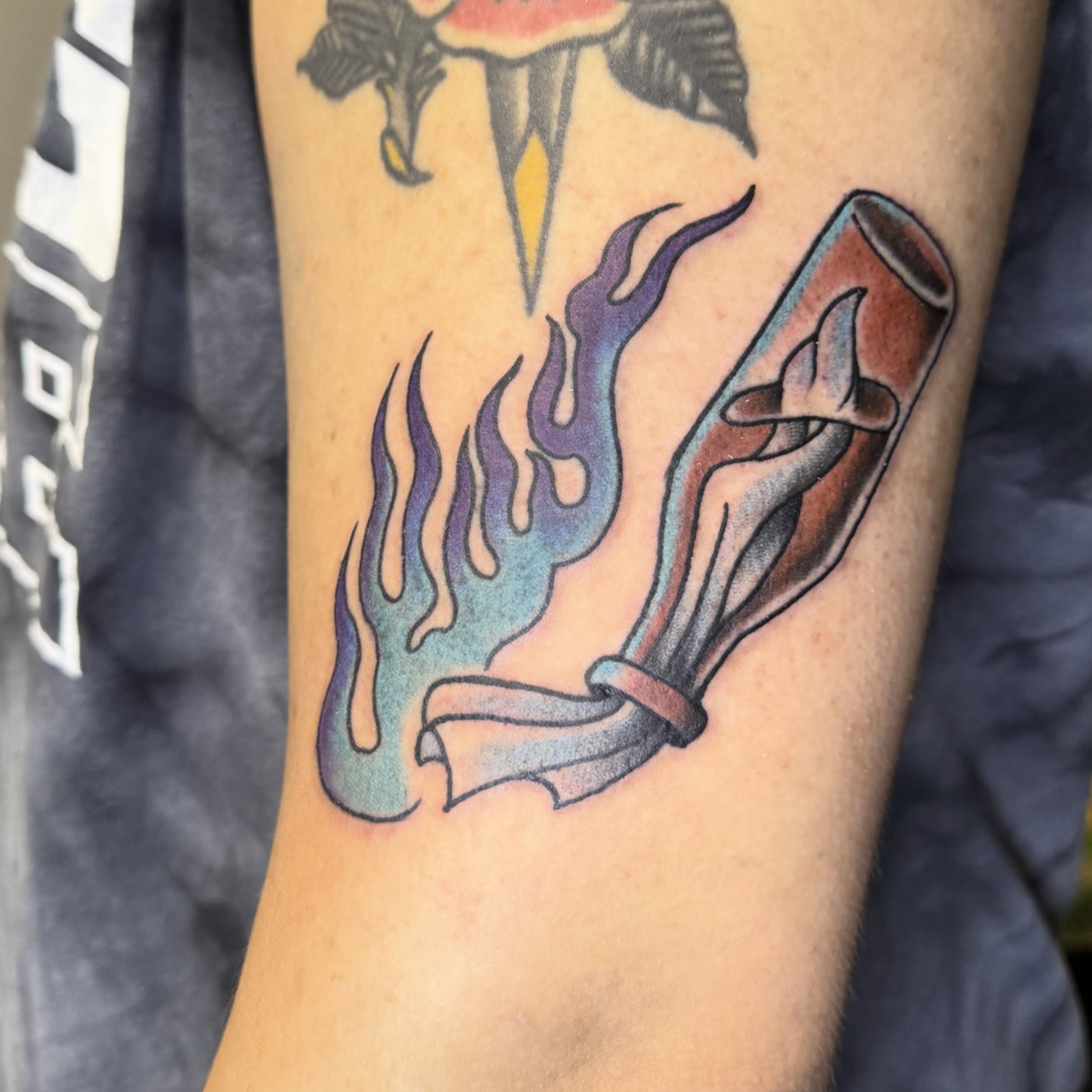 Flame and scroll American traditional tattoo on the forearm by Mike Bean, Minneapolis, Minnesota
