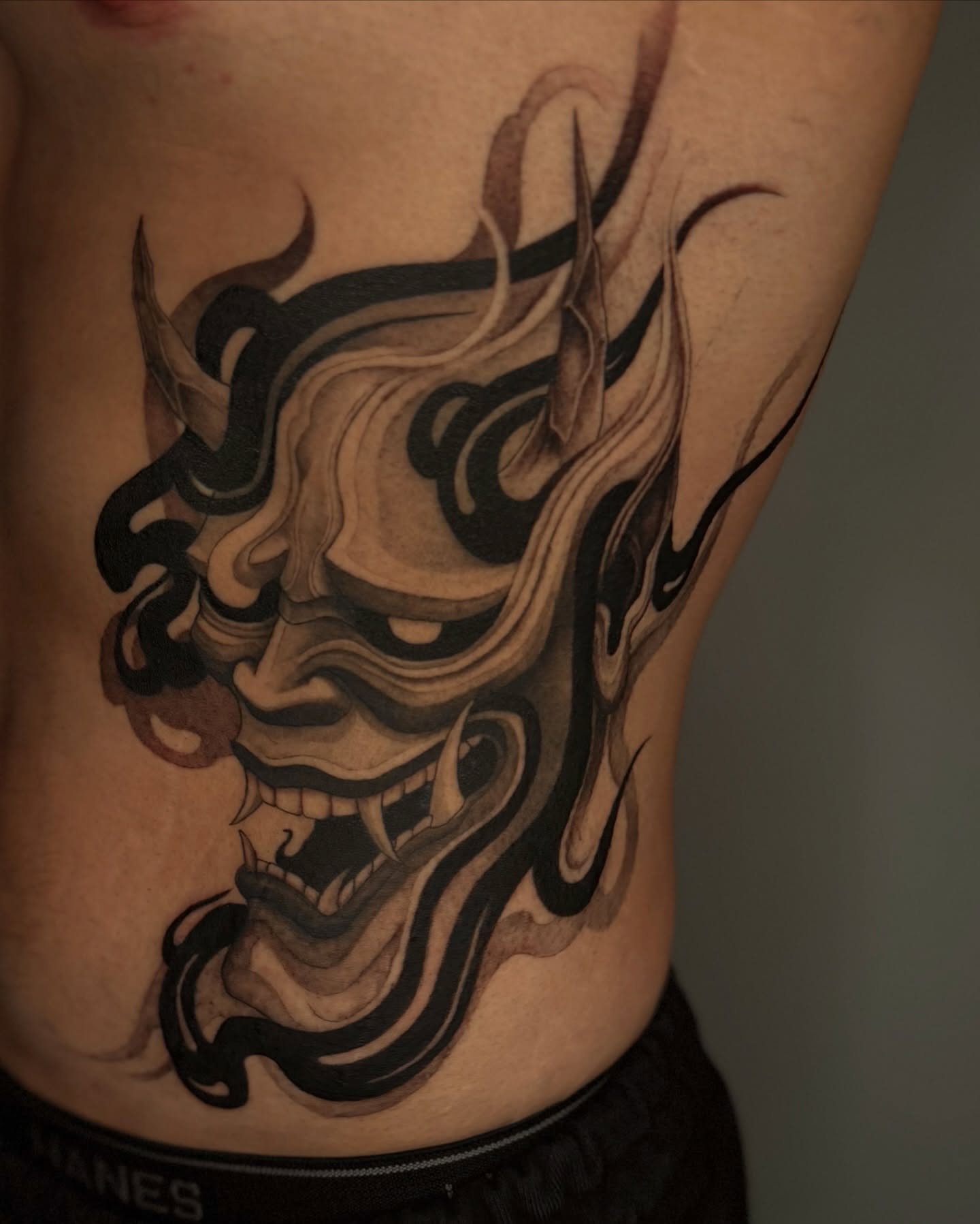 Demon mask japanese irezumi tattoo on the ribs by Sab