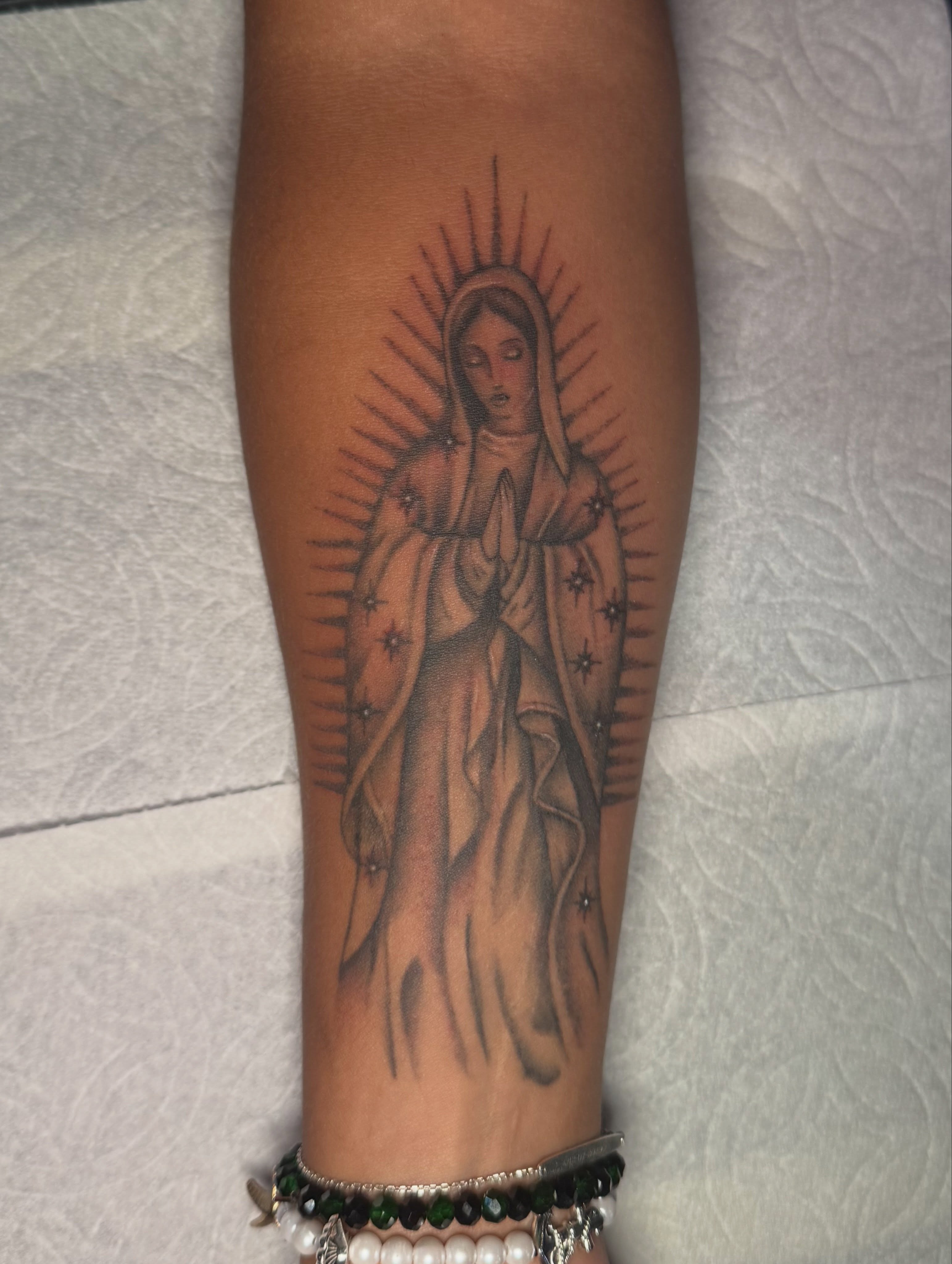 Virgin mary black and grey tattoo on the forearm by Nathalie Briseno