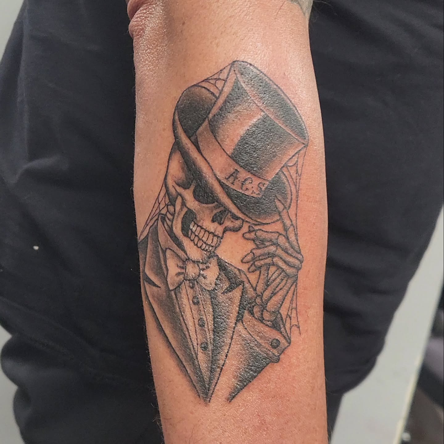Skull in top hat realism tattoo on the forearm by Jason August