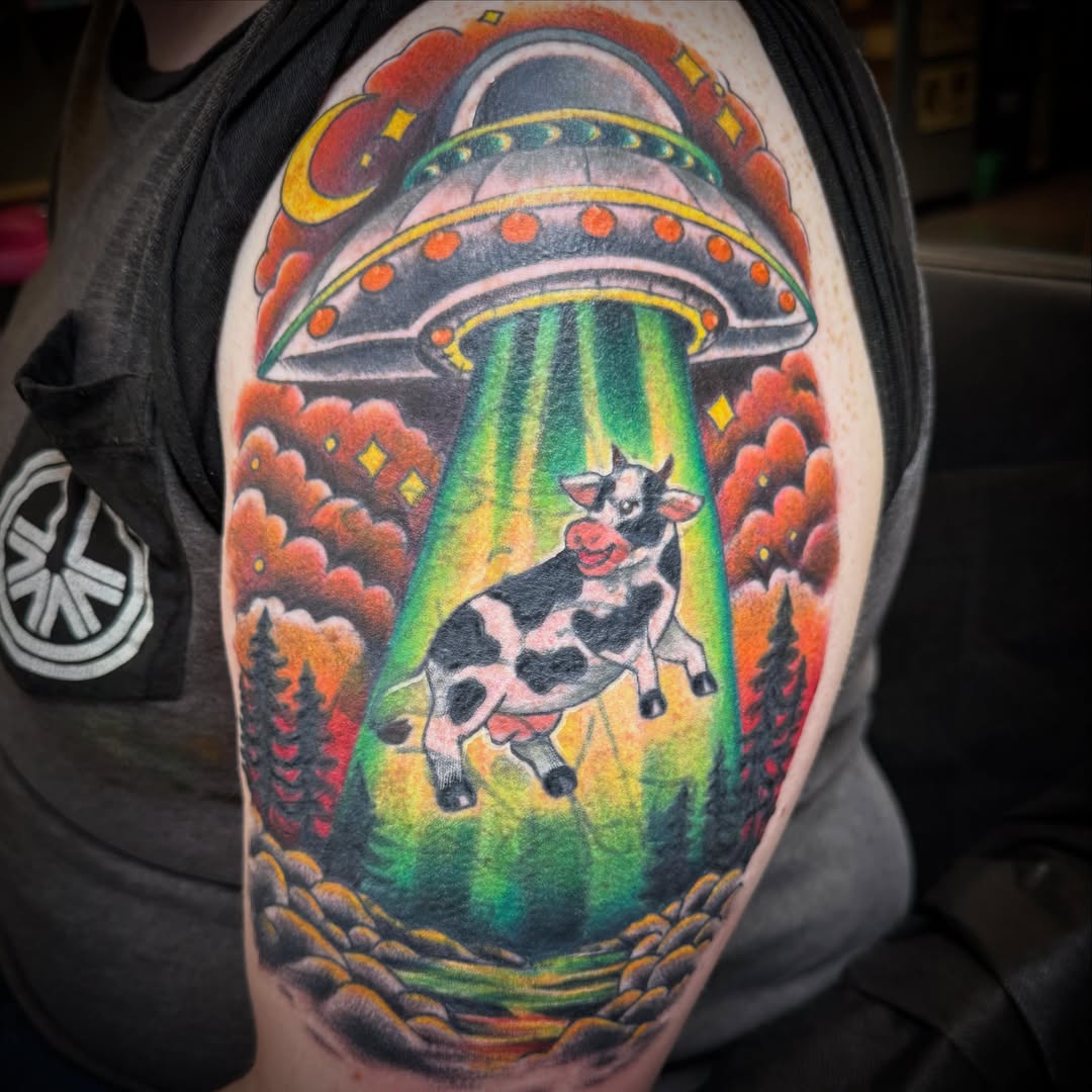 Cow abduction new school tattoo on the shoulder by ArJay Smith
