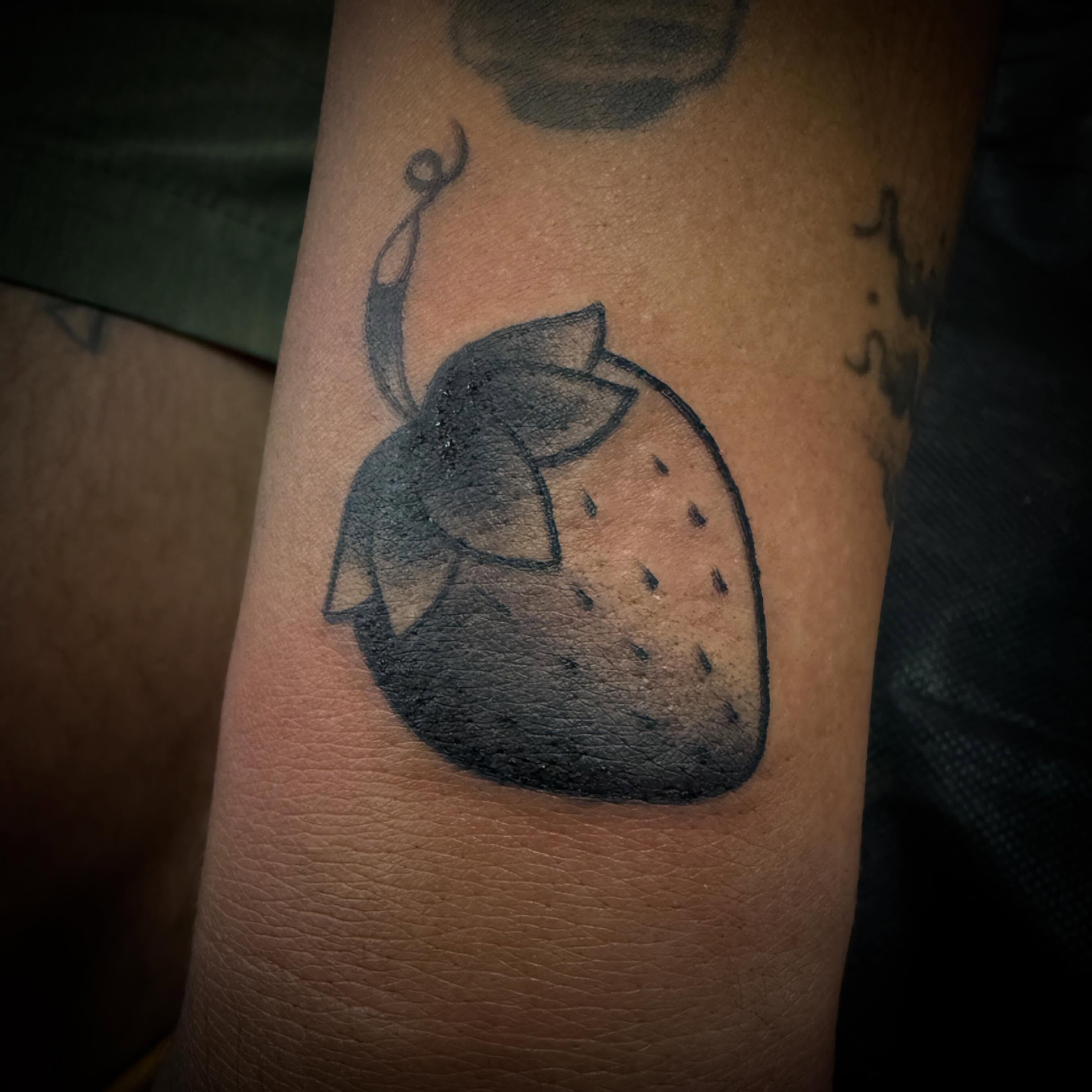 Strawberry black and grey tattoo on the forearm by ArJay Smith