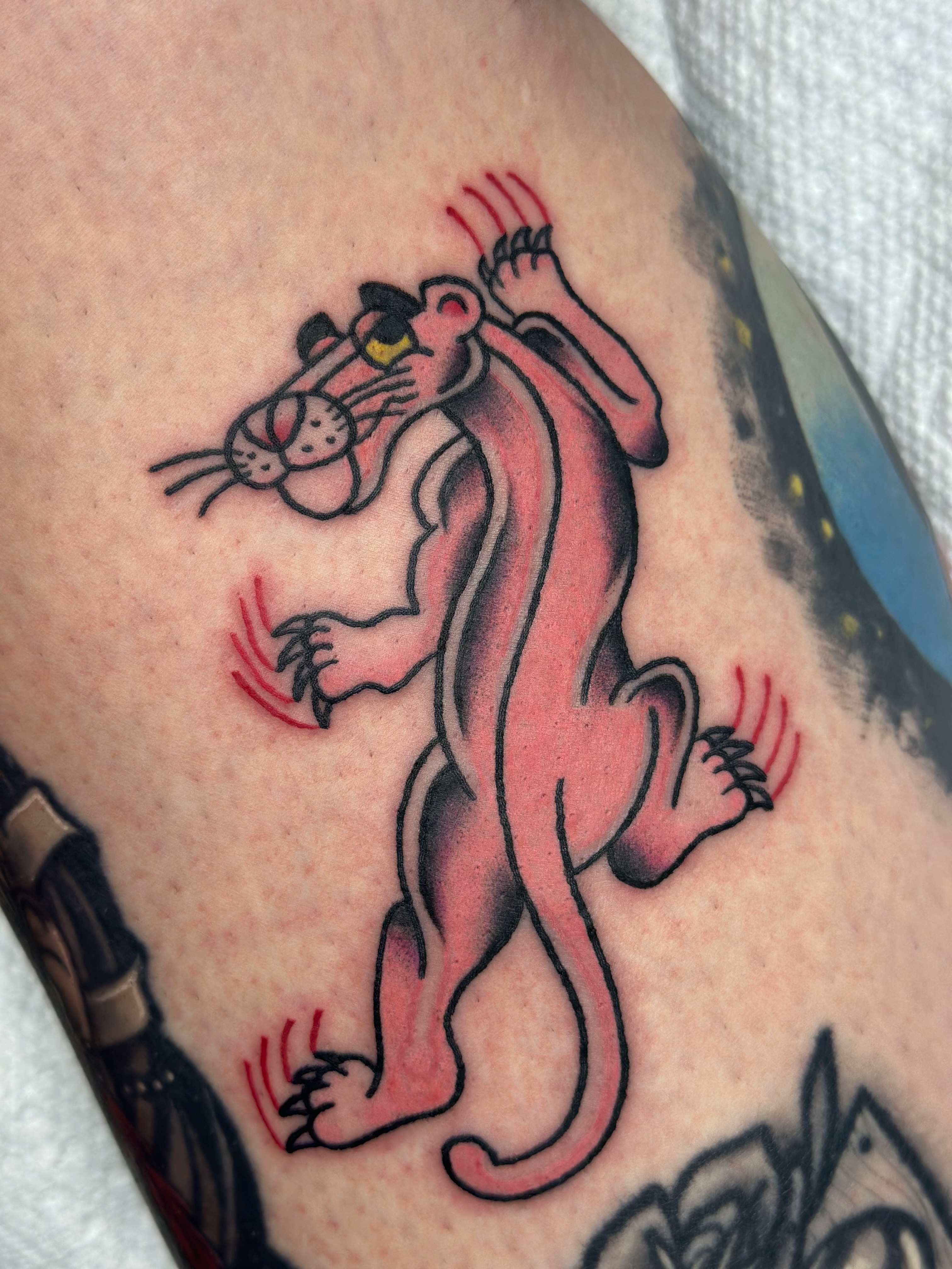 Pink panther American traditional tattoo on the forearm by Lucy Jay