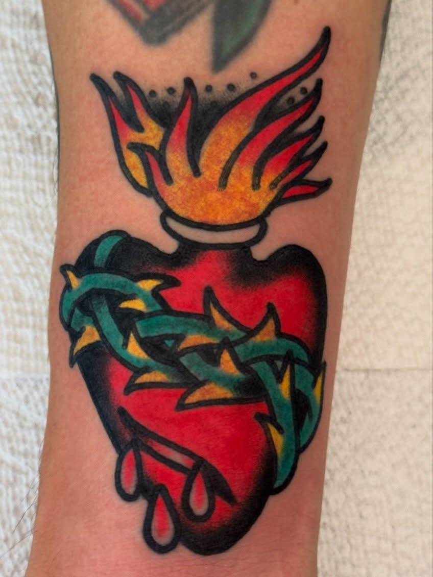 Heart with flames and thorns American traditional tattoo on the forearm by Kenny Kastro