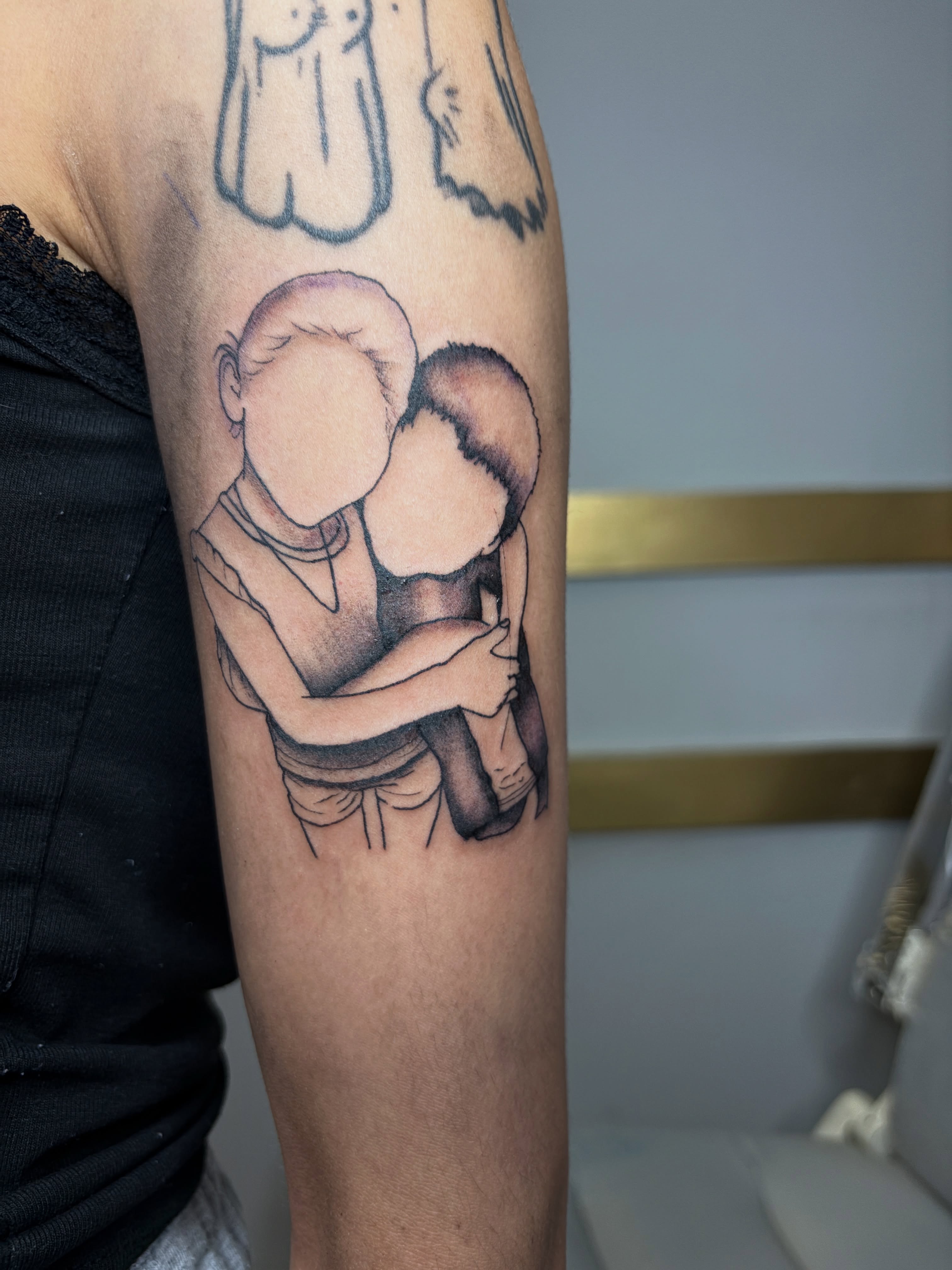 Mother and child black and grey tattoo on the forearm by Destineé