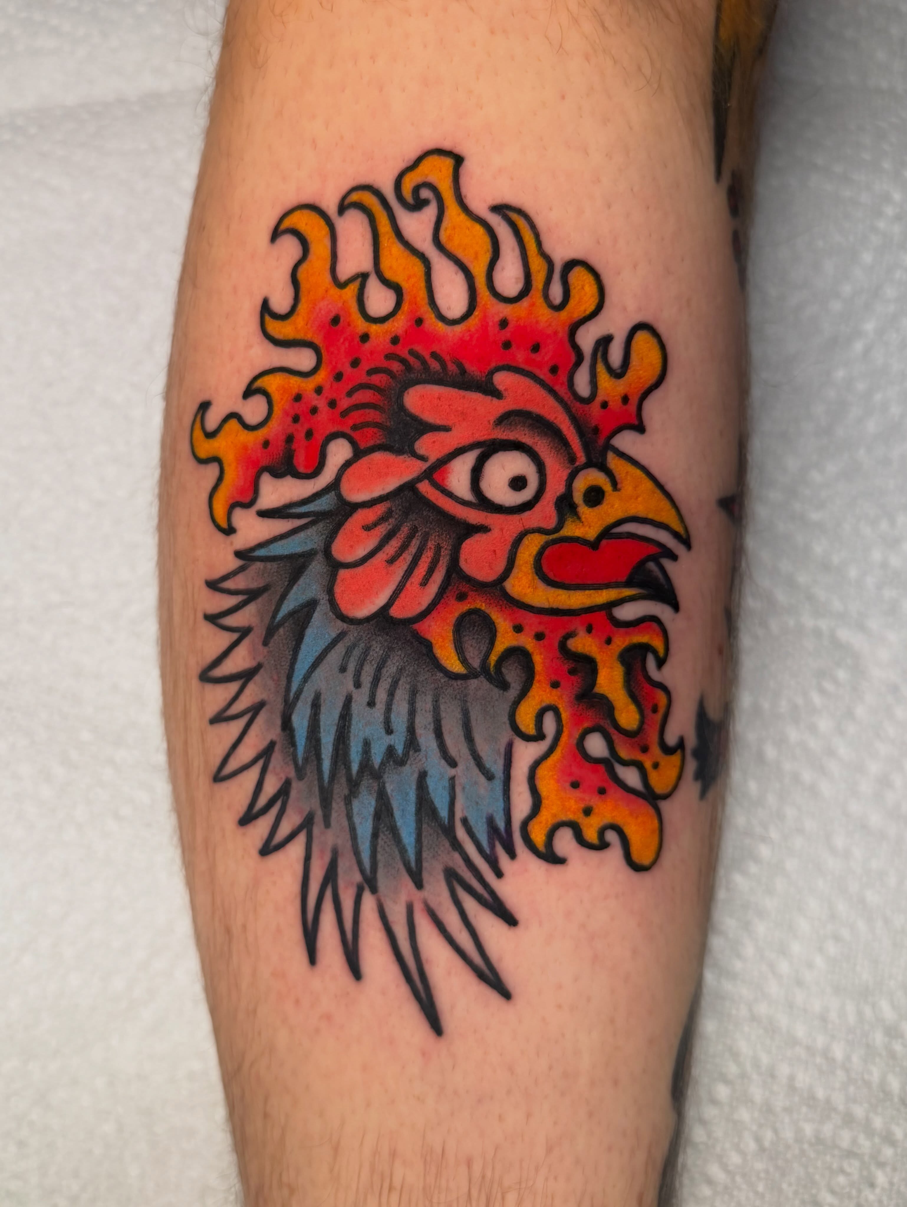 Rooster American traditional tattoo on the forearm by Atom Aker