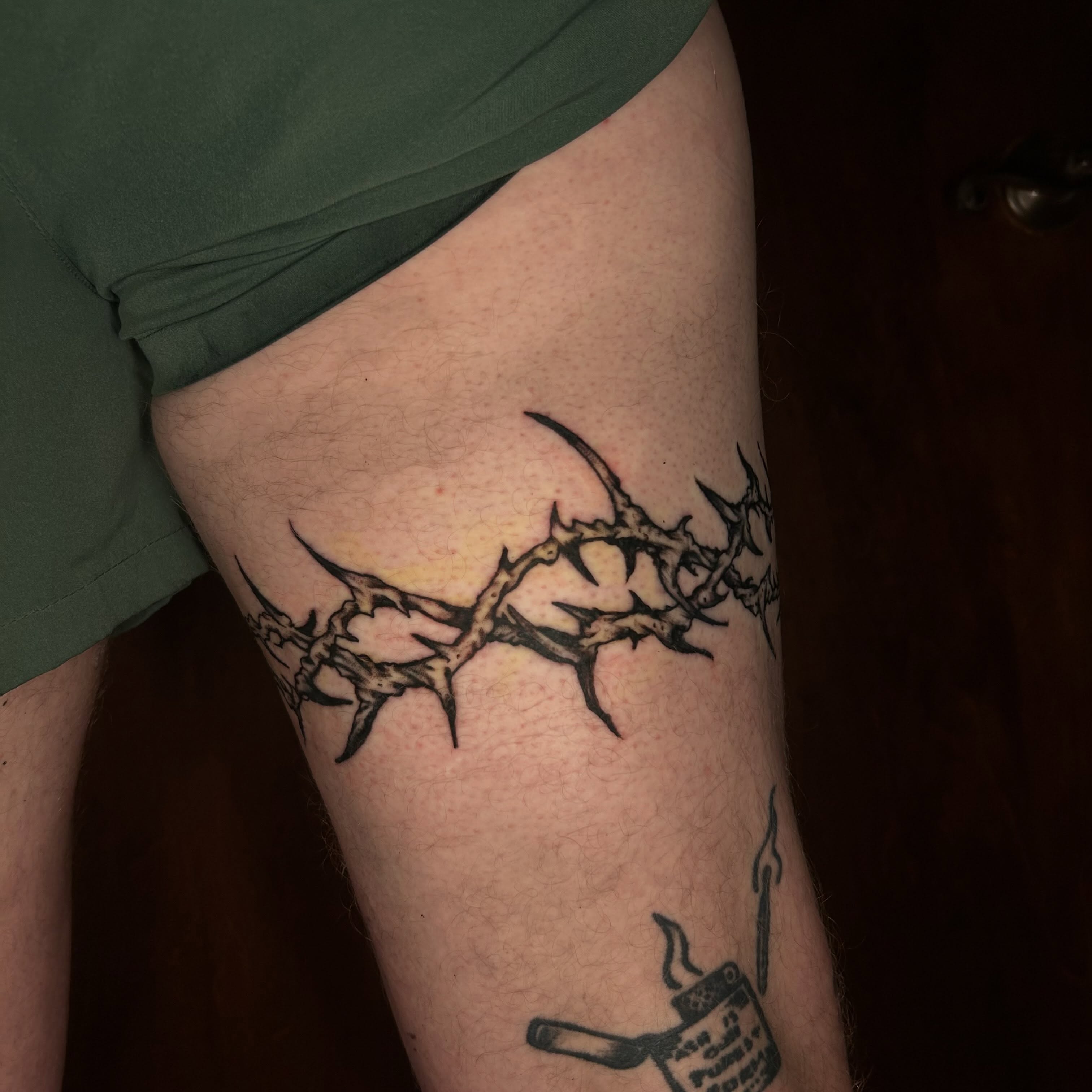 Crown of thorns black and grey tattoo on the thigh by Chuckthegirl
