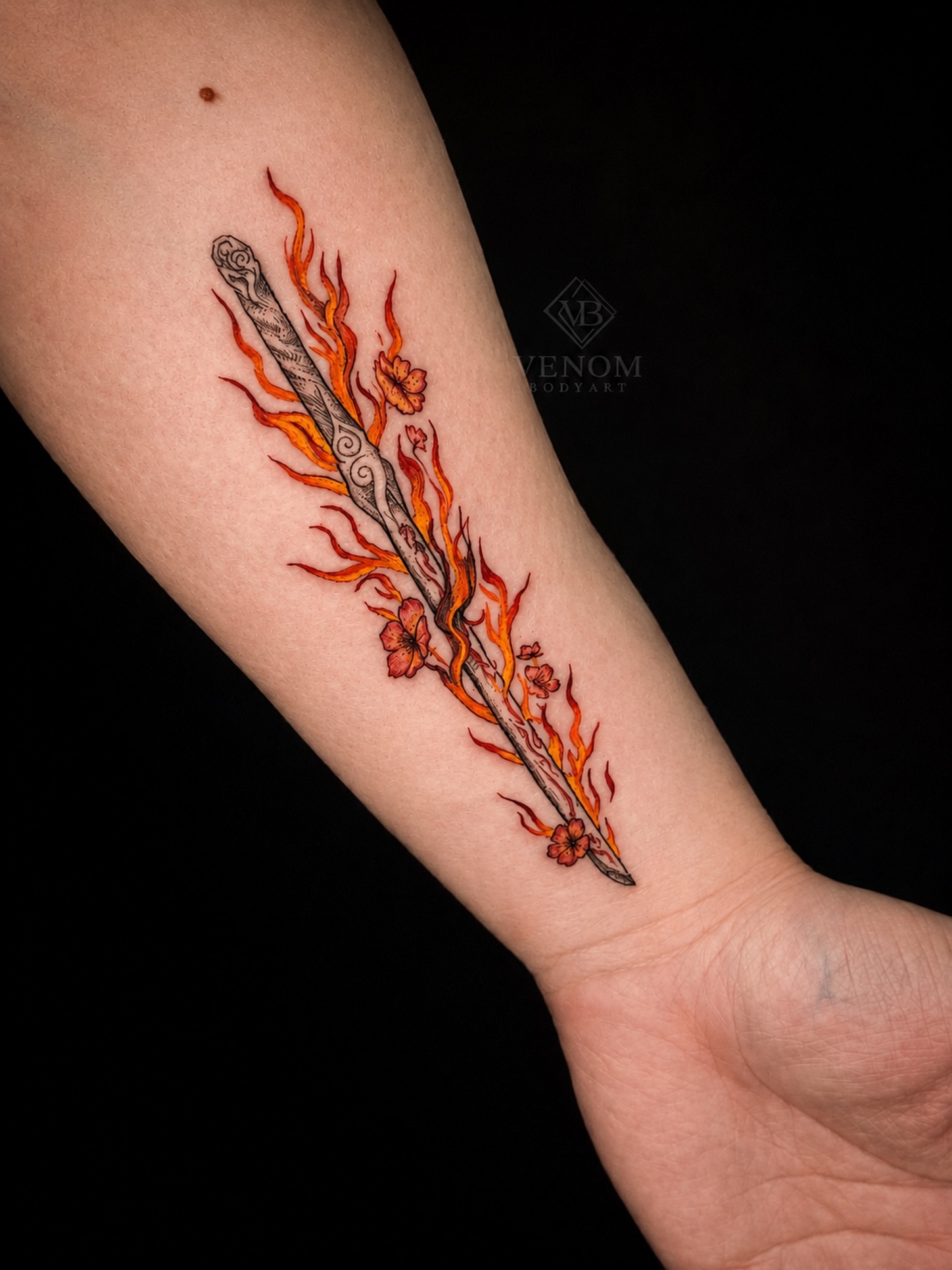 Flaming staff neo-traditional tattoo on the forearm by Jennifer Ramirez
