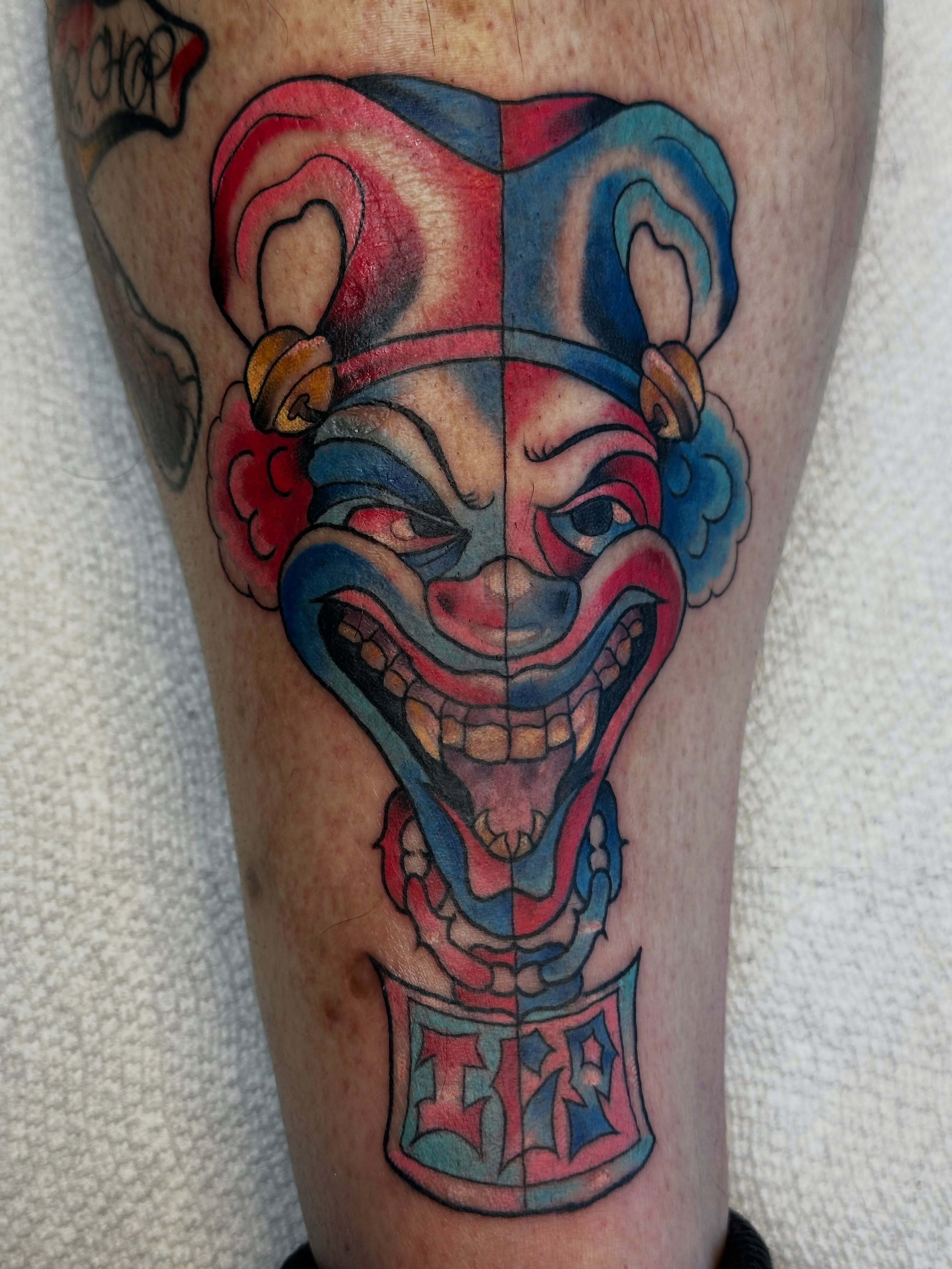 Clown mask American traditional tattoo on the calf by Elisha B🦷