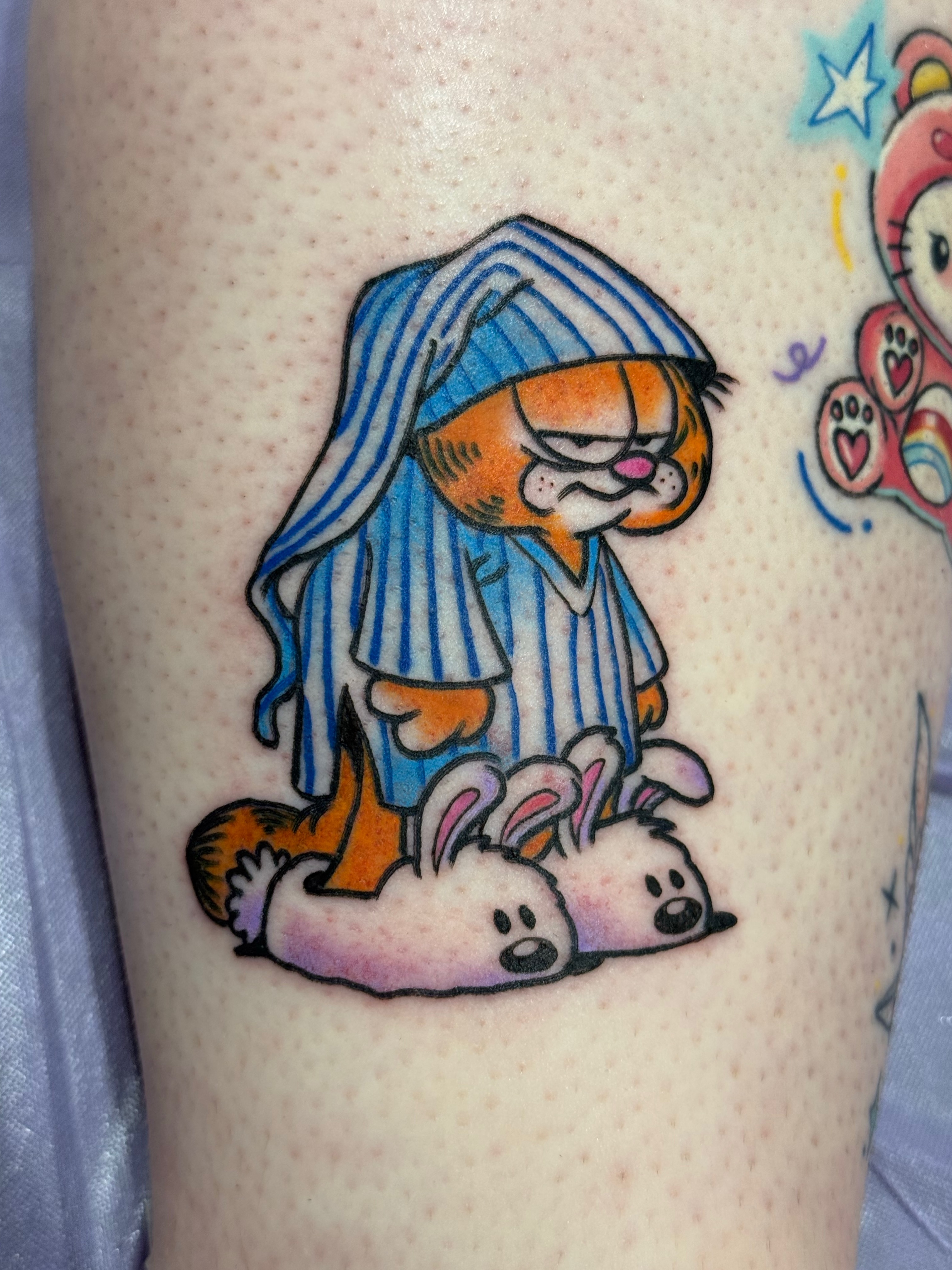 Garfield in pajamas dotwork tattoo on the thigh by Chelsea Graham, Seattle, Washington