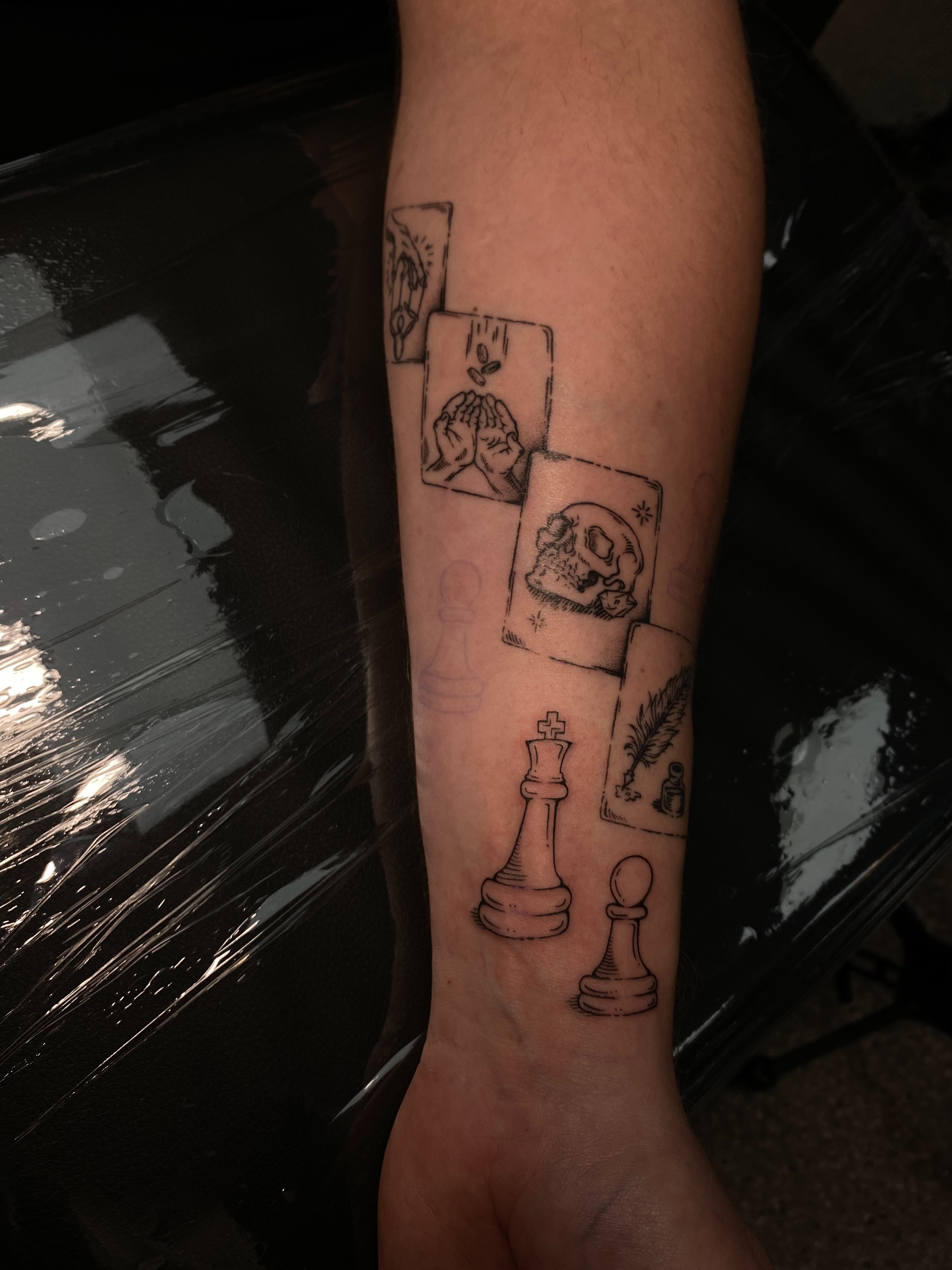 Chess pieces and cards black and grey tattoo on the forearm by 𝕶𝖆𝖒 ~ 𝕿𝖆𝖙𝖙𝖔𝖔 𝕬𝖗𝖙𝖎𝖘𝖙