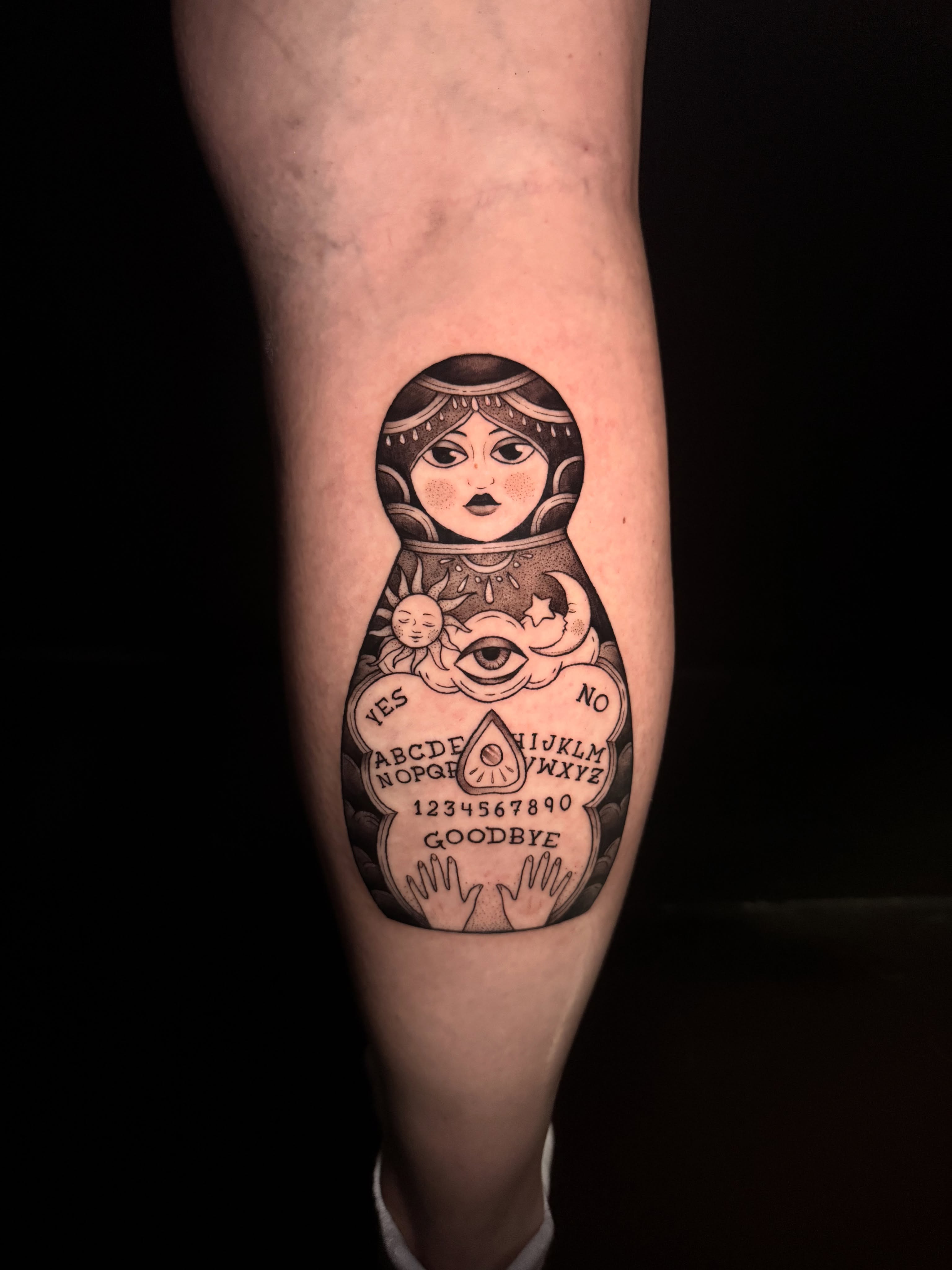 Nested doll ouija board realism tattoo on the forearm by Lauren B