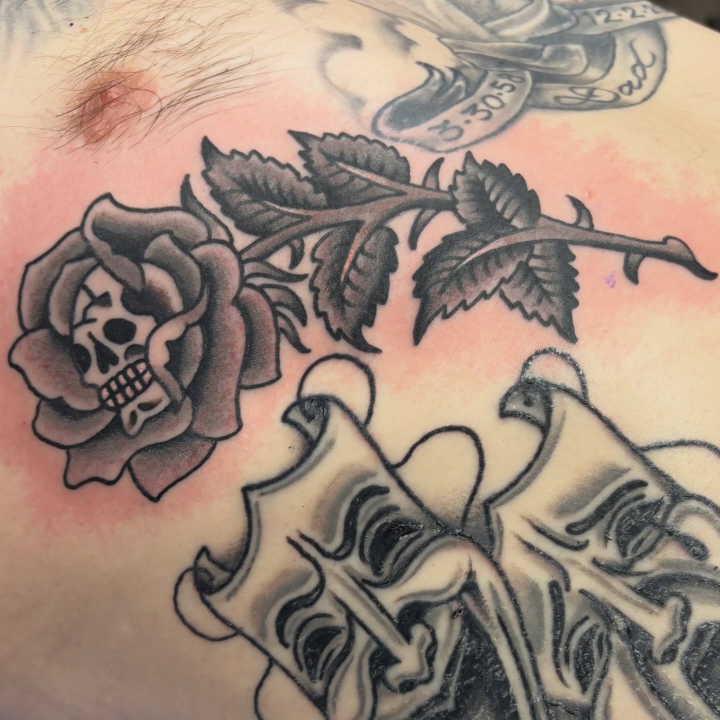 Skull and rose American traditional tattoo on the torso by @dannydoestattoos