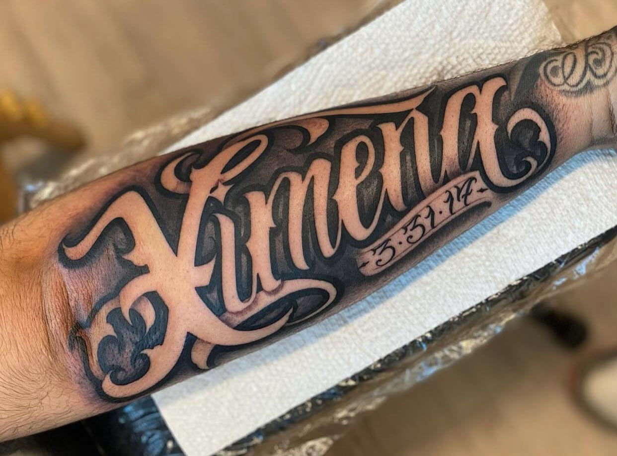Himena lettering script tattoo on the forearm by Lex Miranda