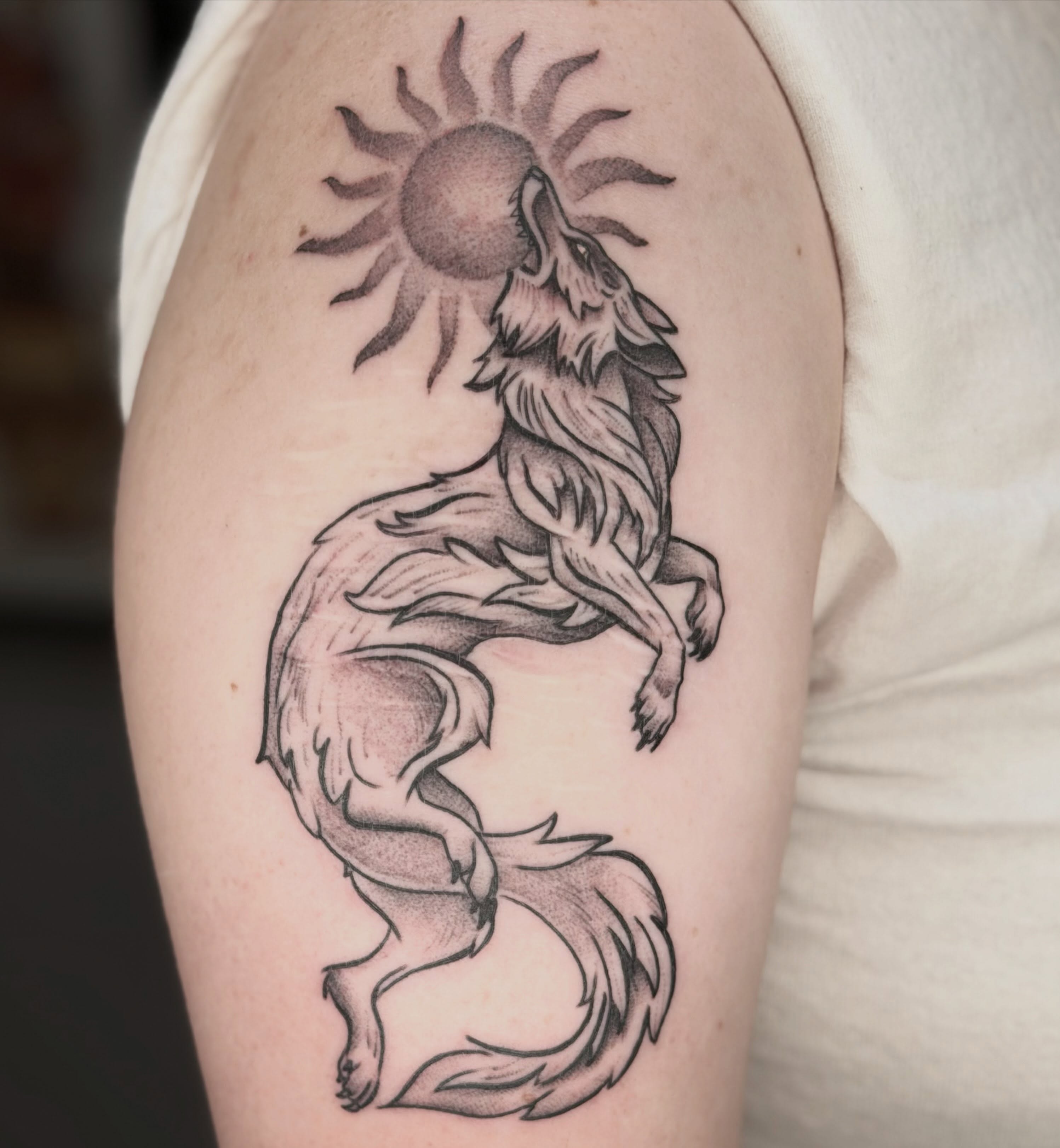 Wolf howling at sun black and grey tattoo on the forearm by Beeker, Bellingham, Washington