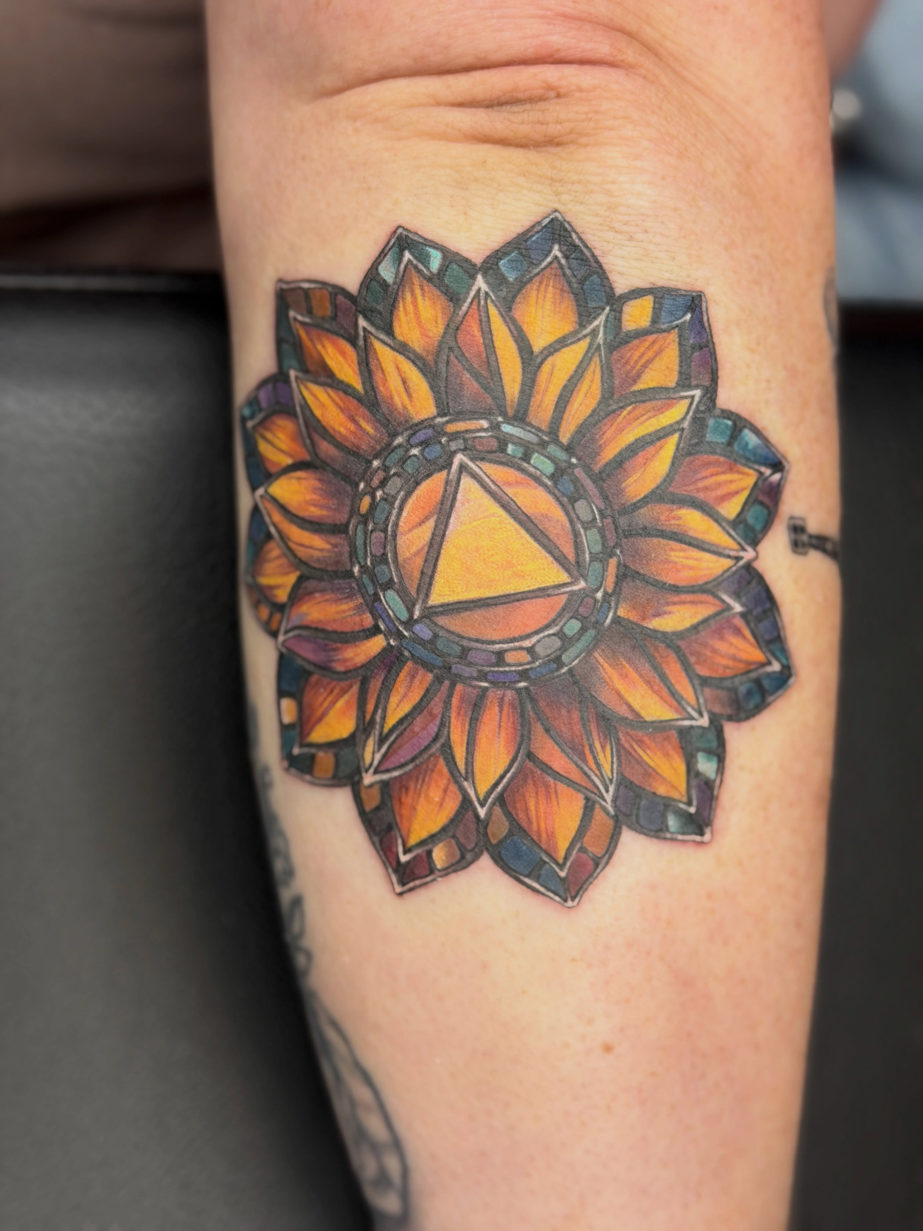 Stained glass sunflower geometric tattoo on the forearm by Melissa Rose Moya
