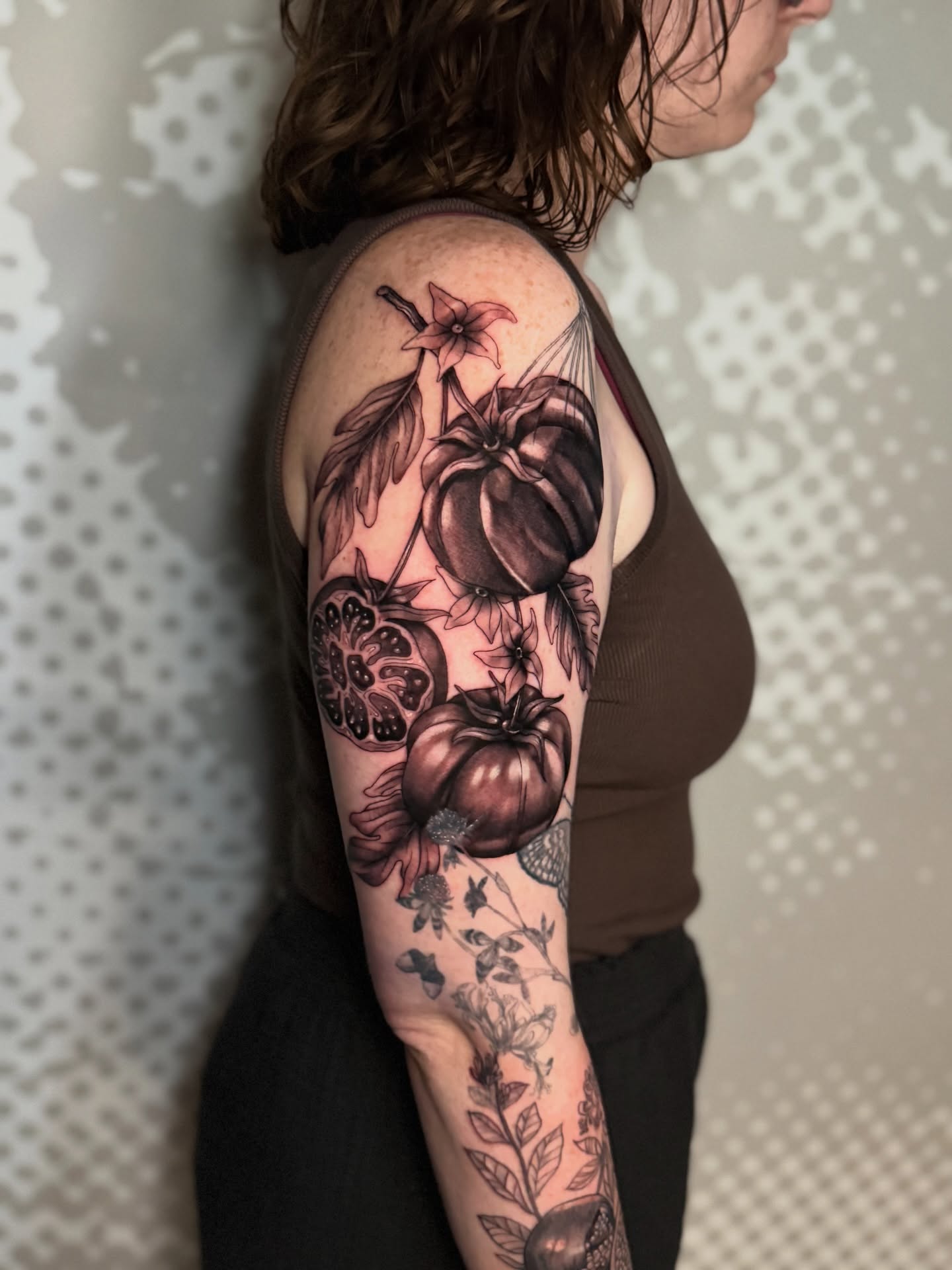 Tomatoes and flowers realism tattoo on the forearm by Charlotte Tattoo Artist