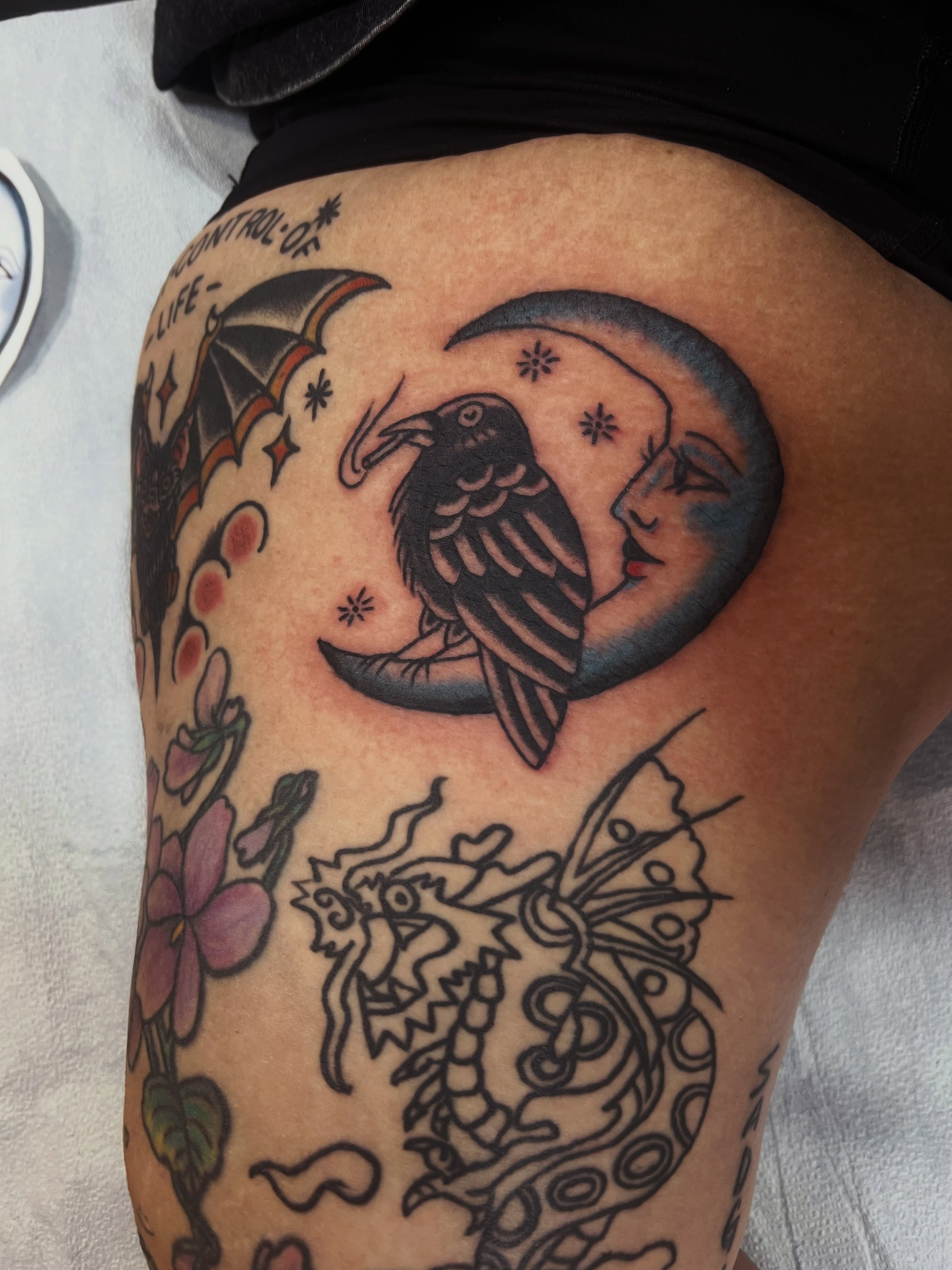 Crow and crescent moon American traditional tattoo on the thigh by Samantha Citer