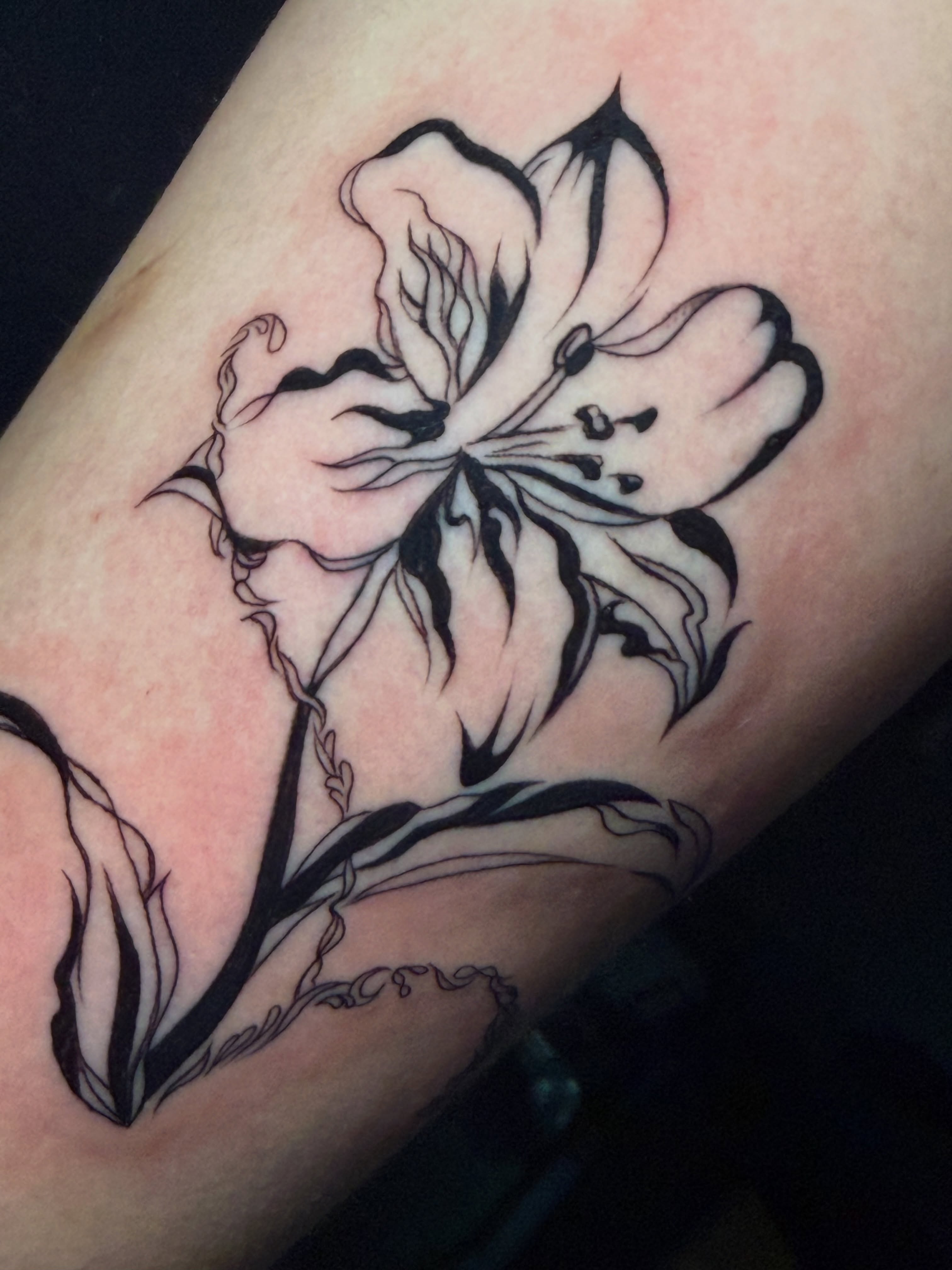 Lily black and grey tattoo on the forearm by tattoo artist (mollz)