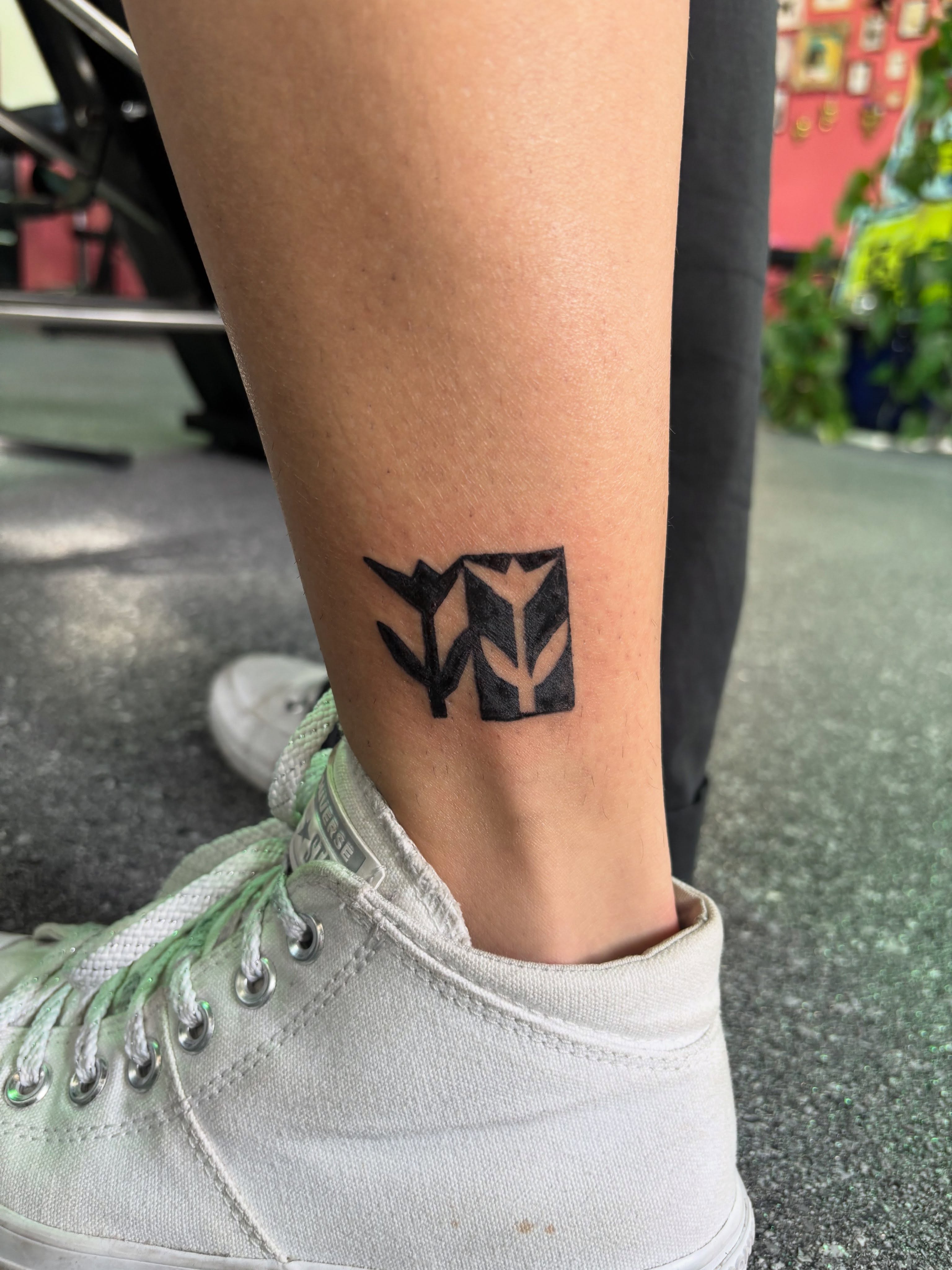 Abstract plant geometric tattoo on the calf by Hiro Robinson