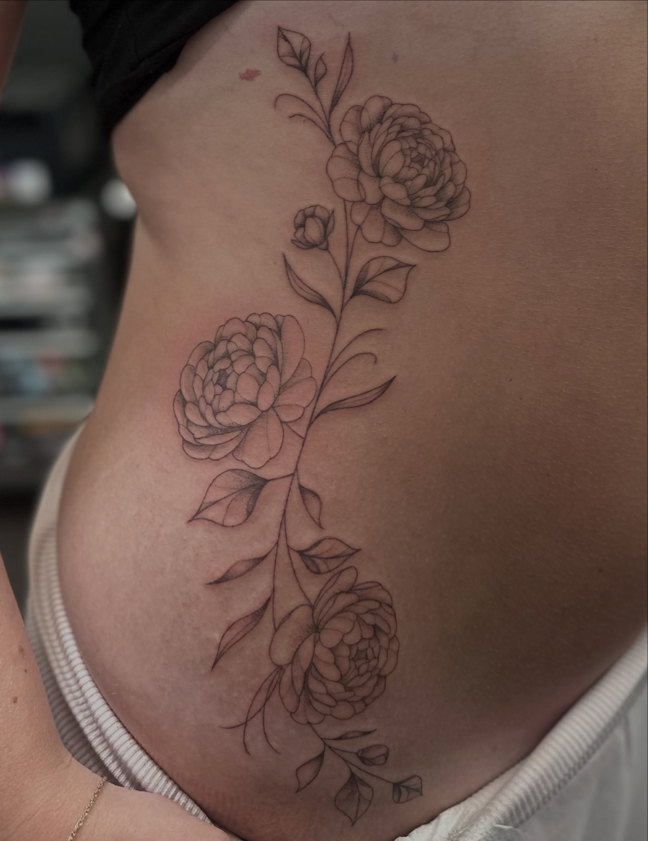 Peony flowers black and grey tattoo on the ribs by Bell