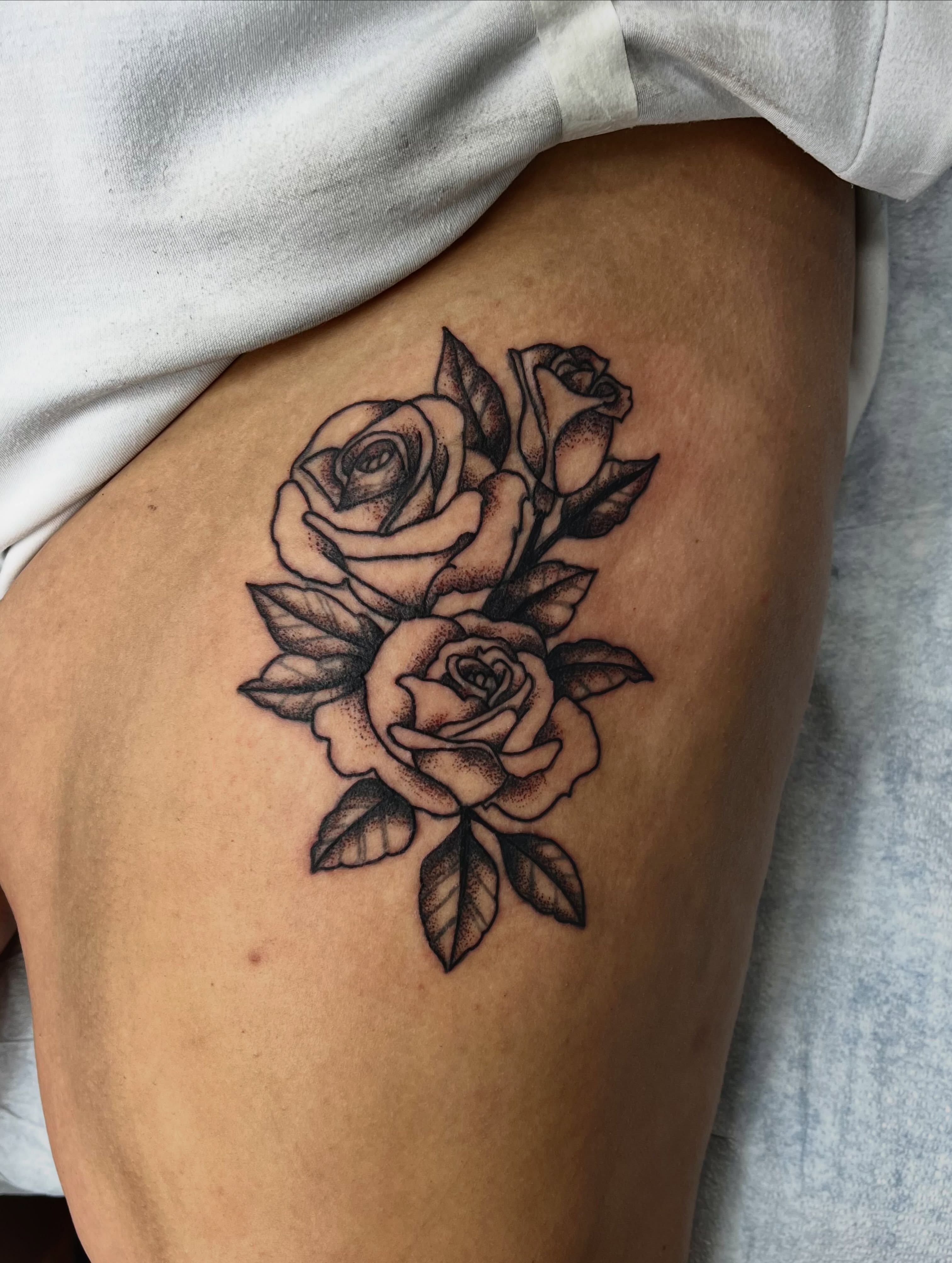 Roses dotwork tattoo on the thigh by Mason McCubbin