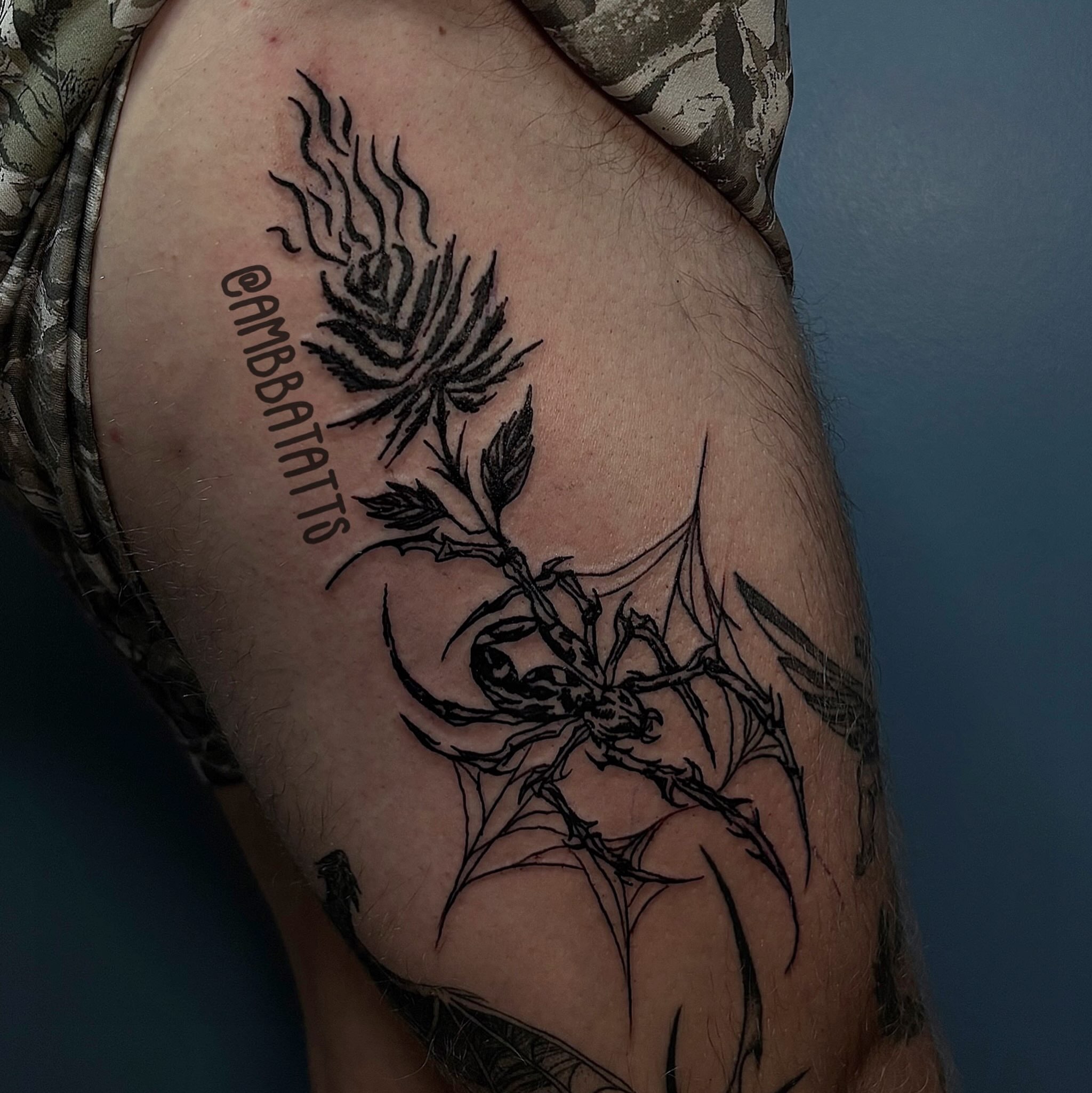 Spider and thistle black and grey tattoo on the thigh by amber brady, Brunswick, Ohio