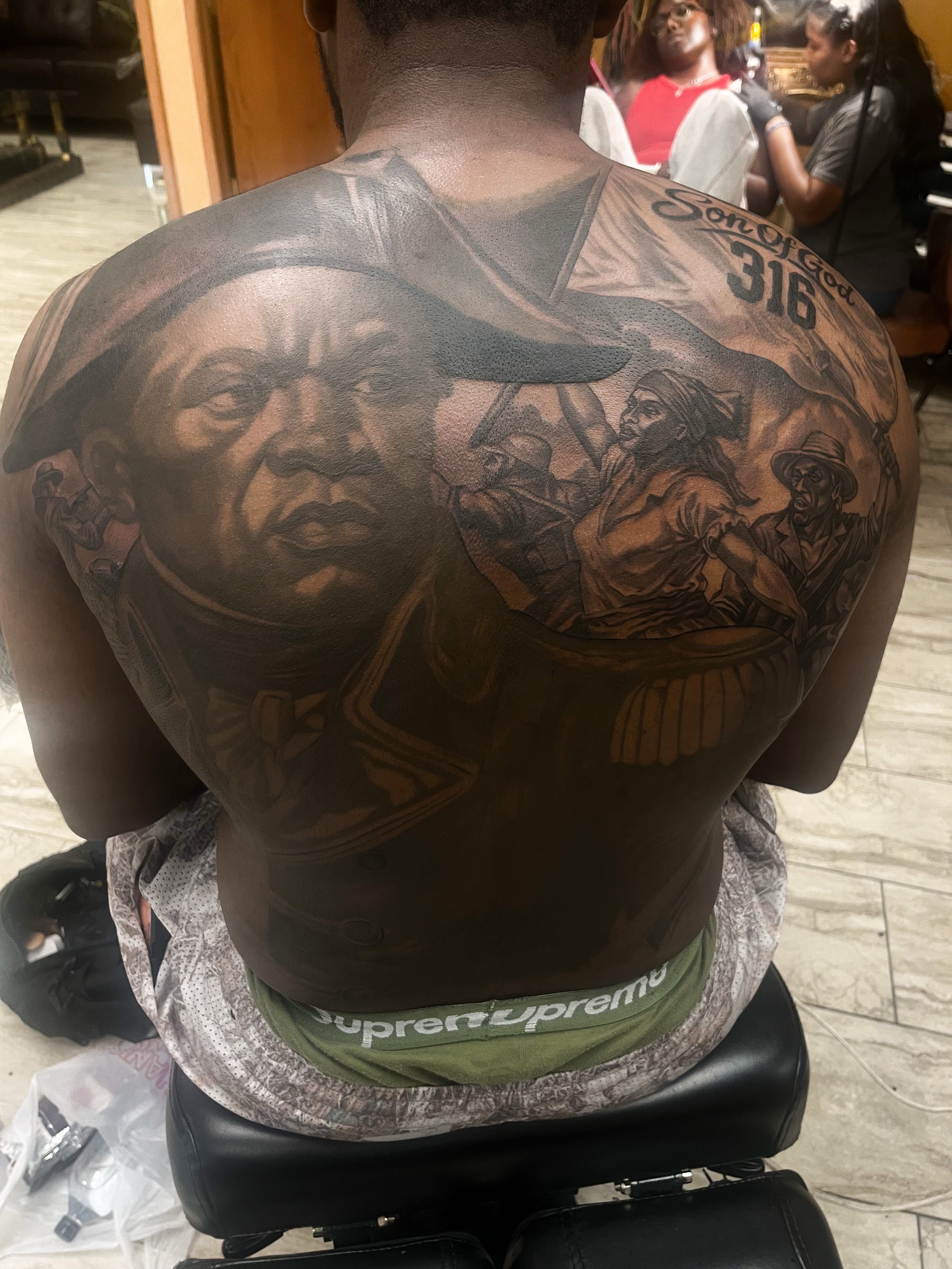 Portrait of a man realism tattoo on the back by Quinten Harper