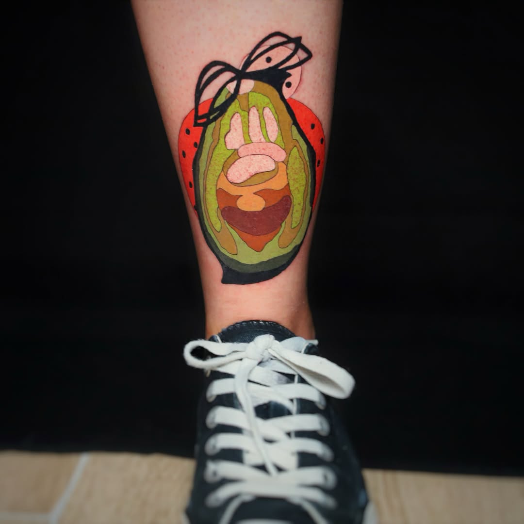 Avocado ladybug tattoo on the forearm by Yana Aizen