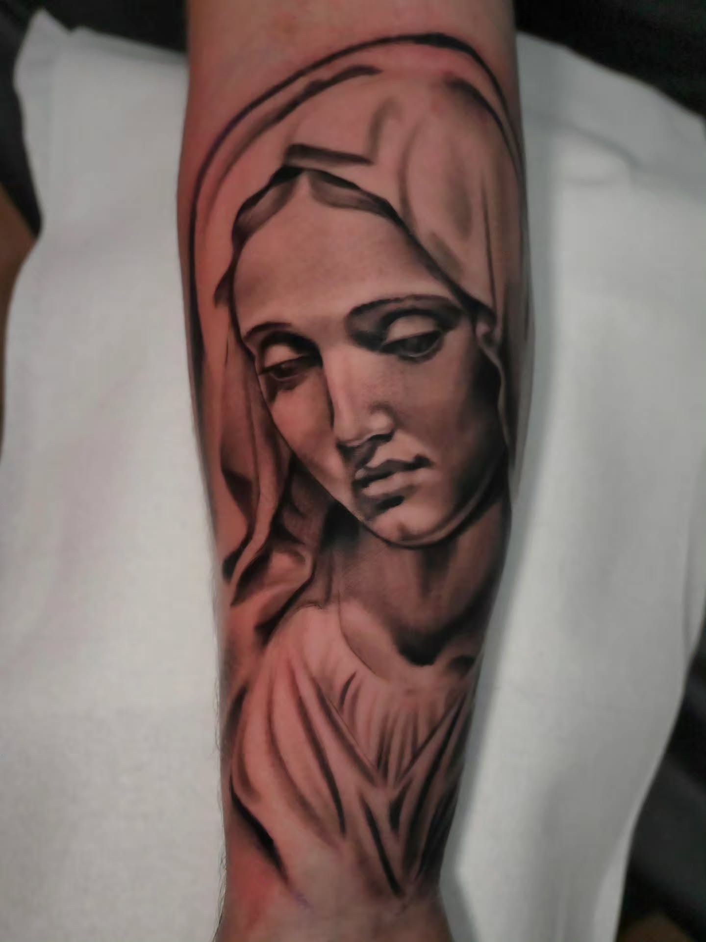 Woman's face realism tattoo on the forearm by Michael ORegan
