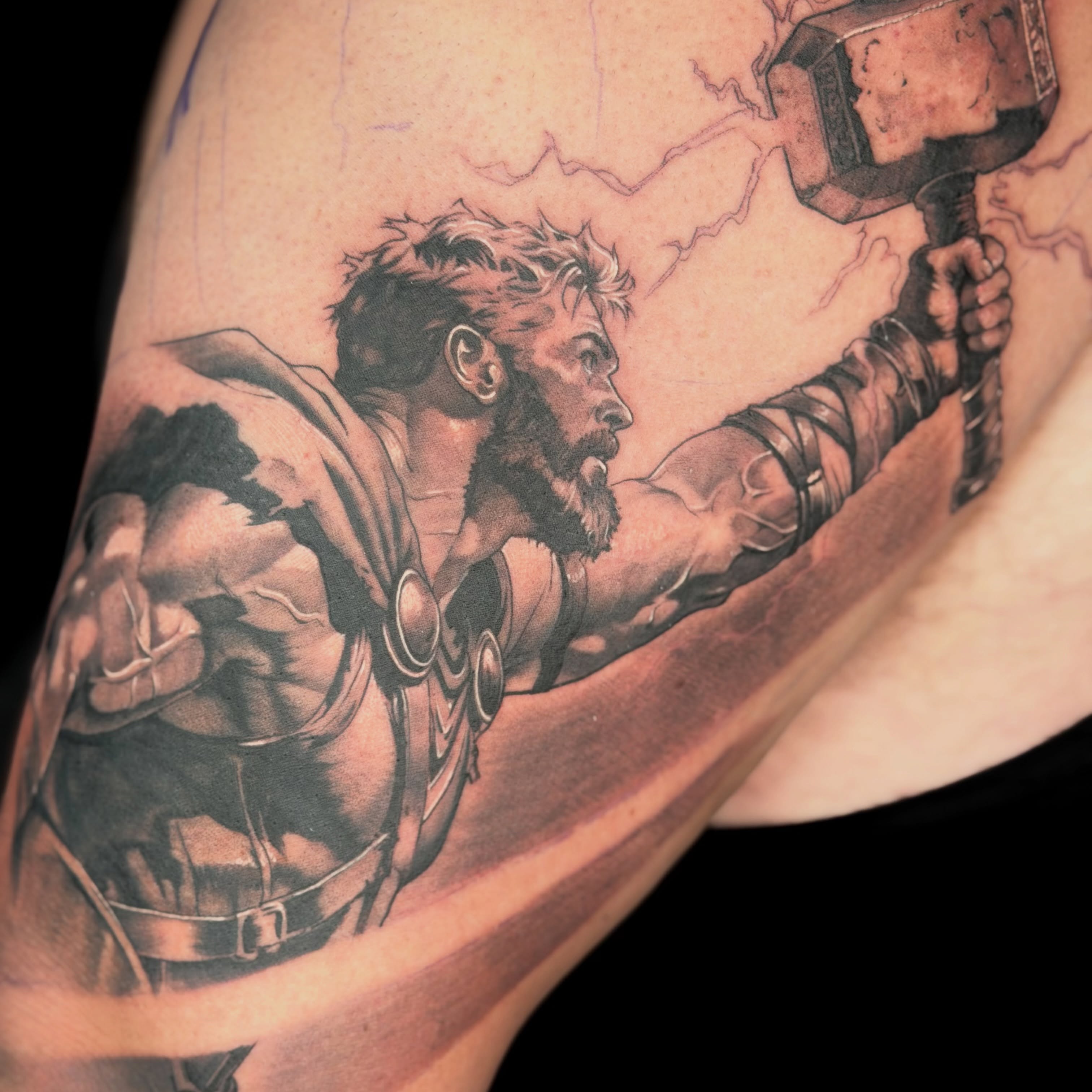 Thor black and grey tattoo on the upper arm by Apologies tattoo studios.