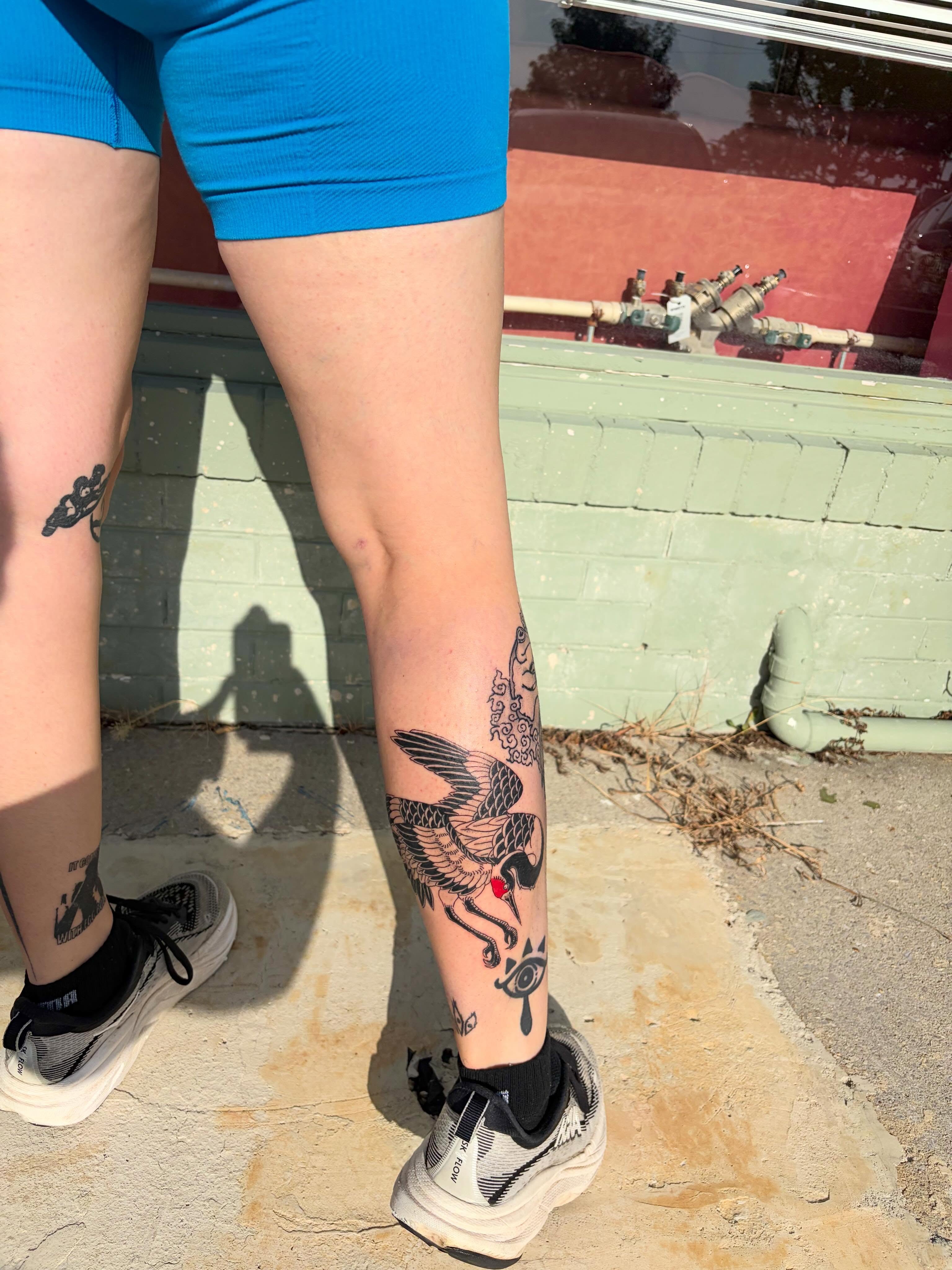 Bird and eye American traditional tattoo on the calf by neal