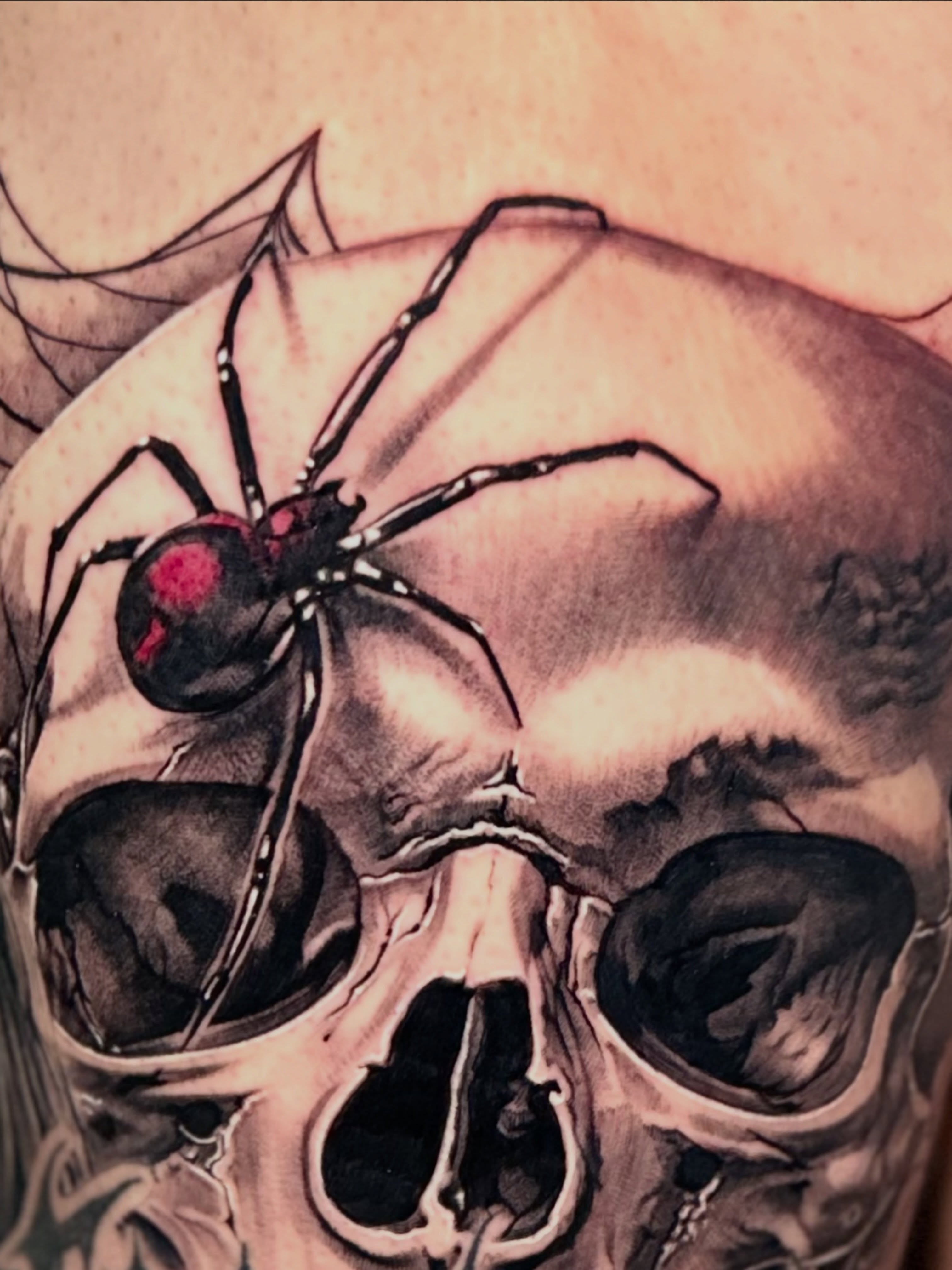 Black widow spider realism tattoo on the chest by Flames, Cerritos, California