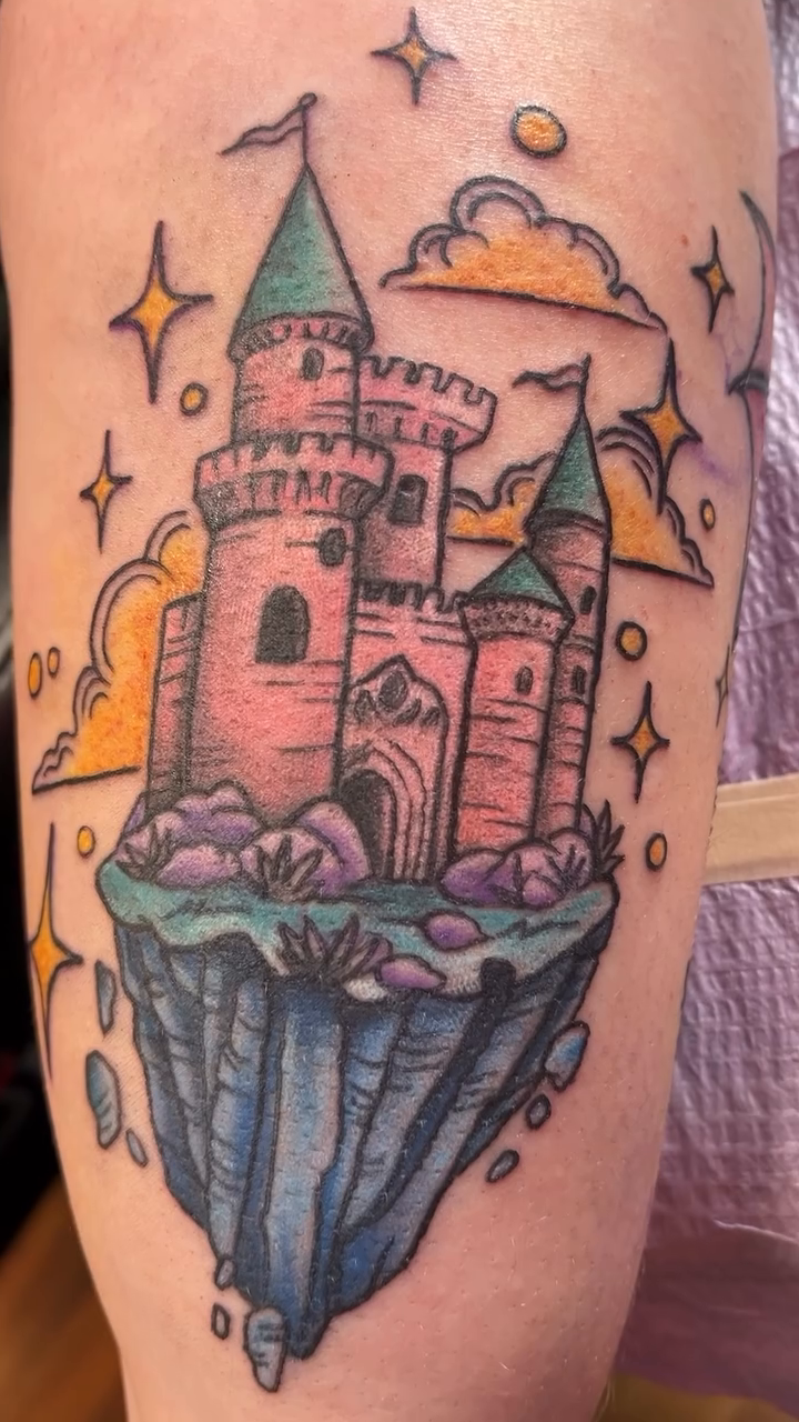 Floating castle new school tattoo on the thigh by Cortney "Fett" Fettinger, Fort Wayne, Indiana