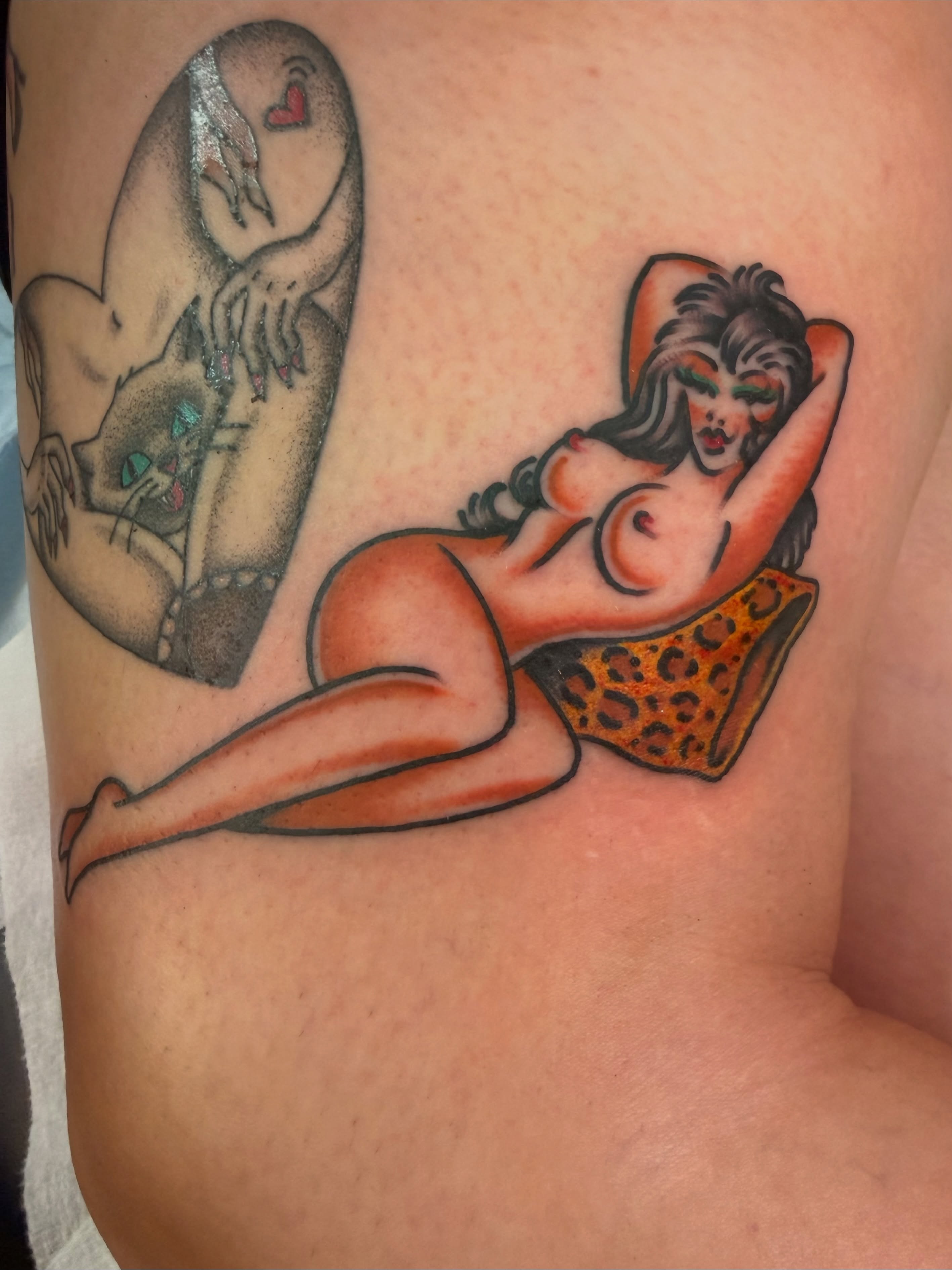 Pin-up girl American traditional tattoo on the thigh by Macy Bird
