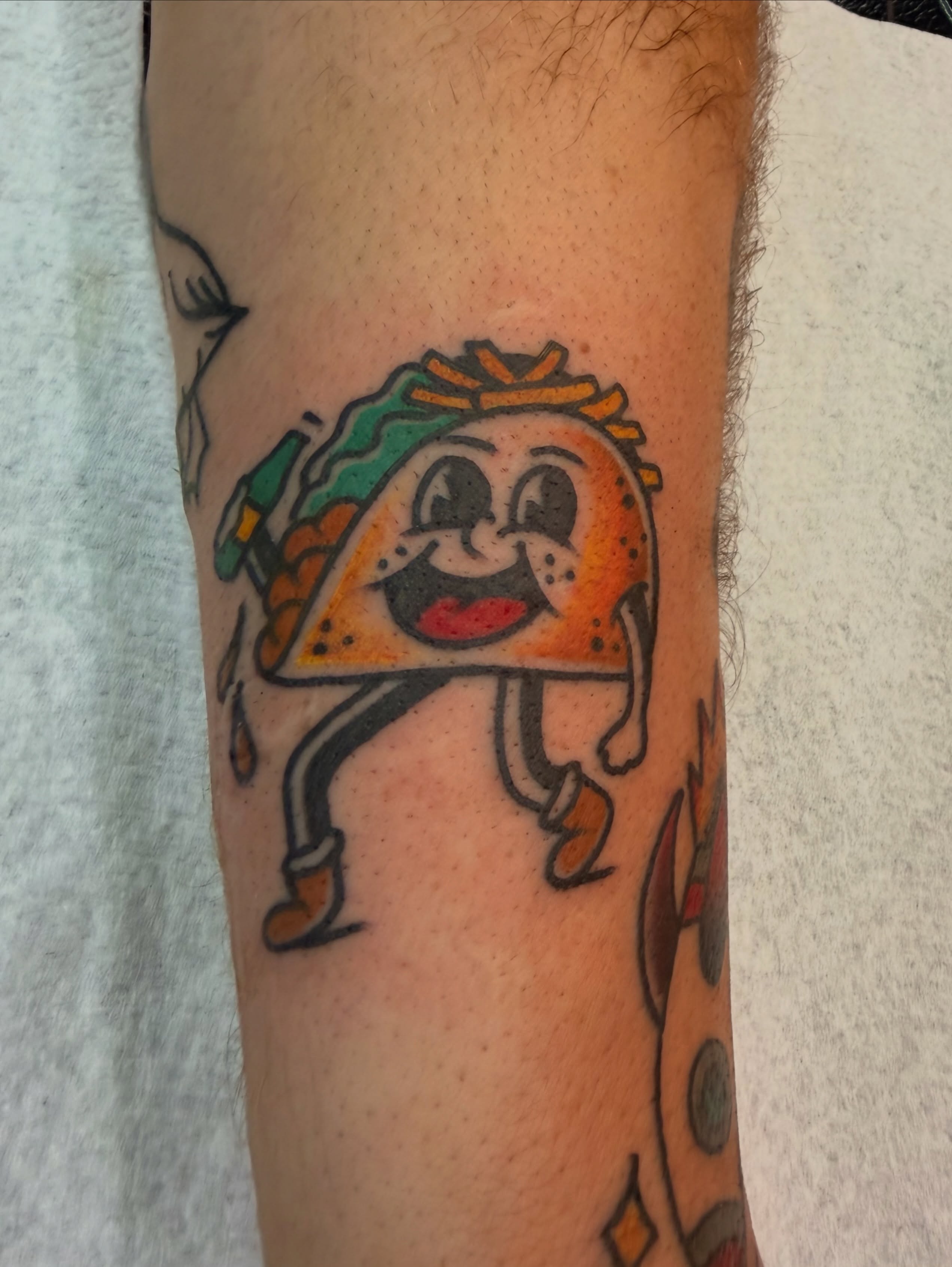 Taco character American traditional tattoo on the forearm by Macy Bird