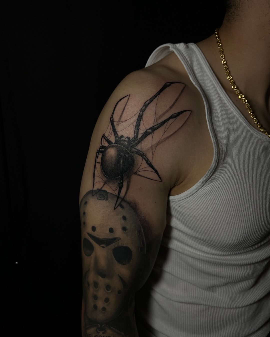 Spider and hockey mask realism tattoo on the upper arm by Iraymi Beltran