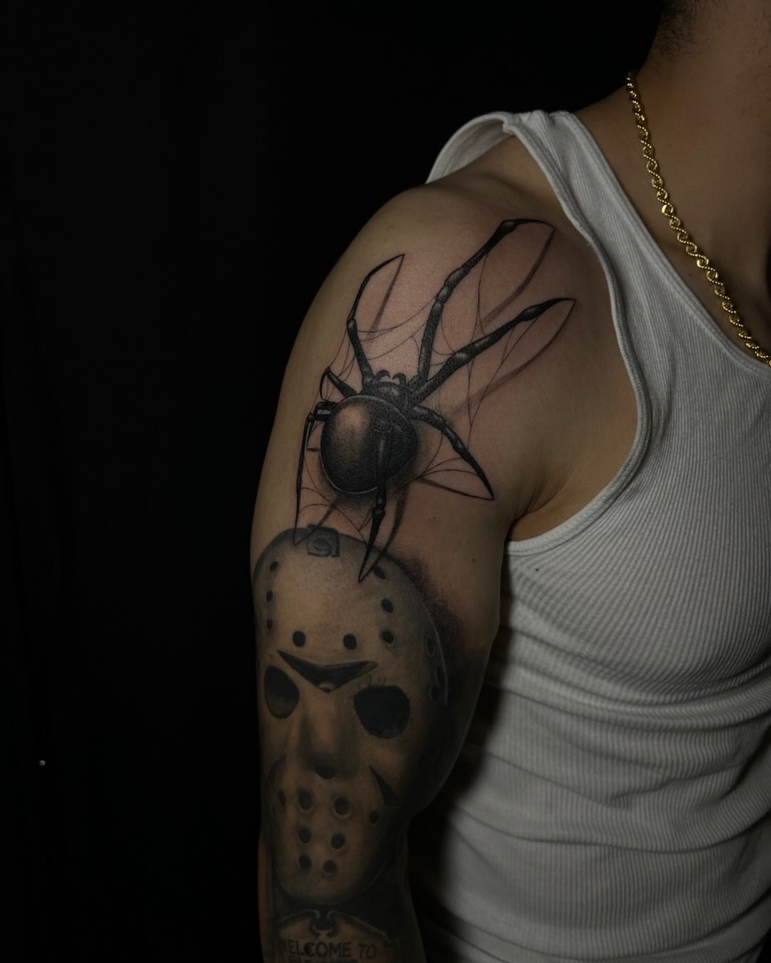 Spider and hockey mask realism tattoo on the upper arm by Iraymi Beltran