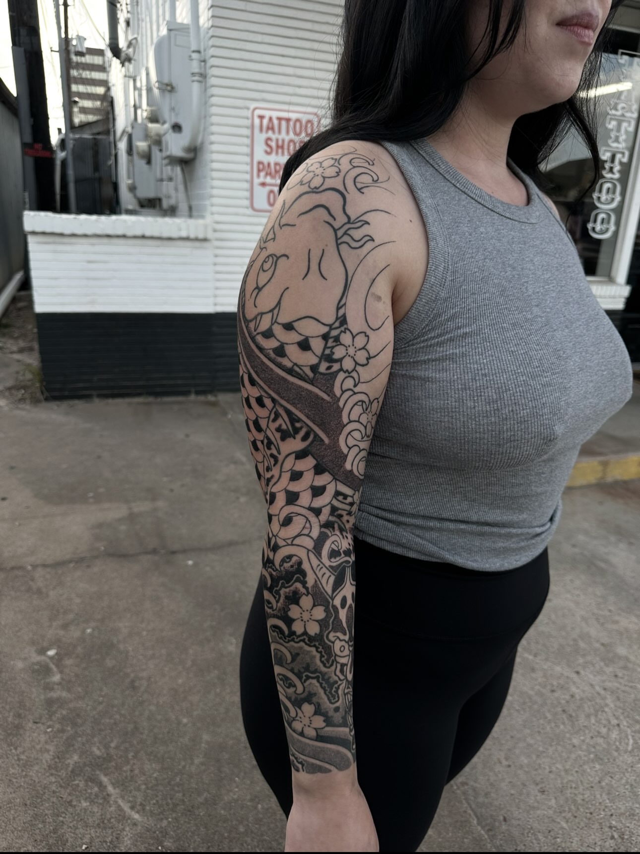 Dragon and flowers japanese irezumi tattoo on the upper arm by Logan Perry