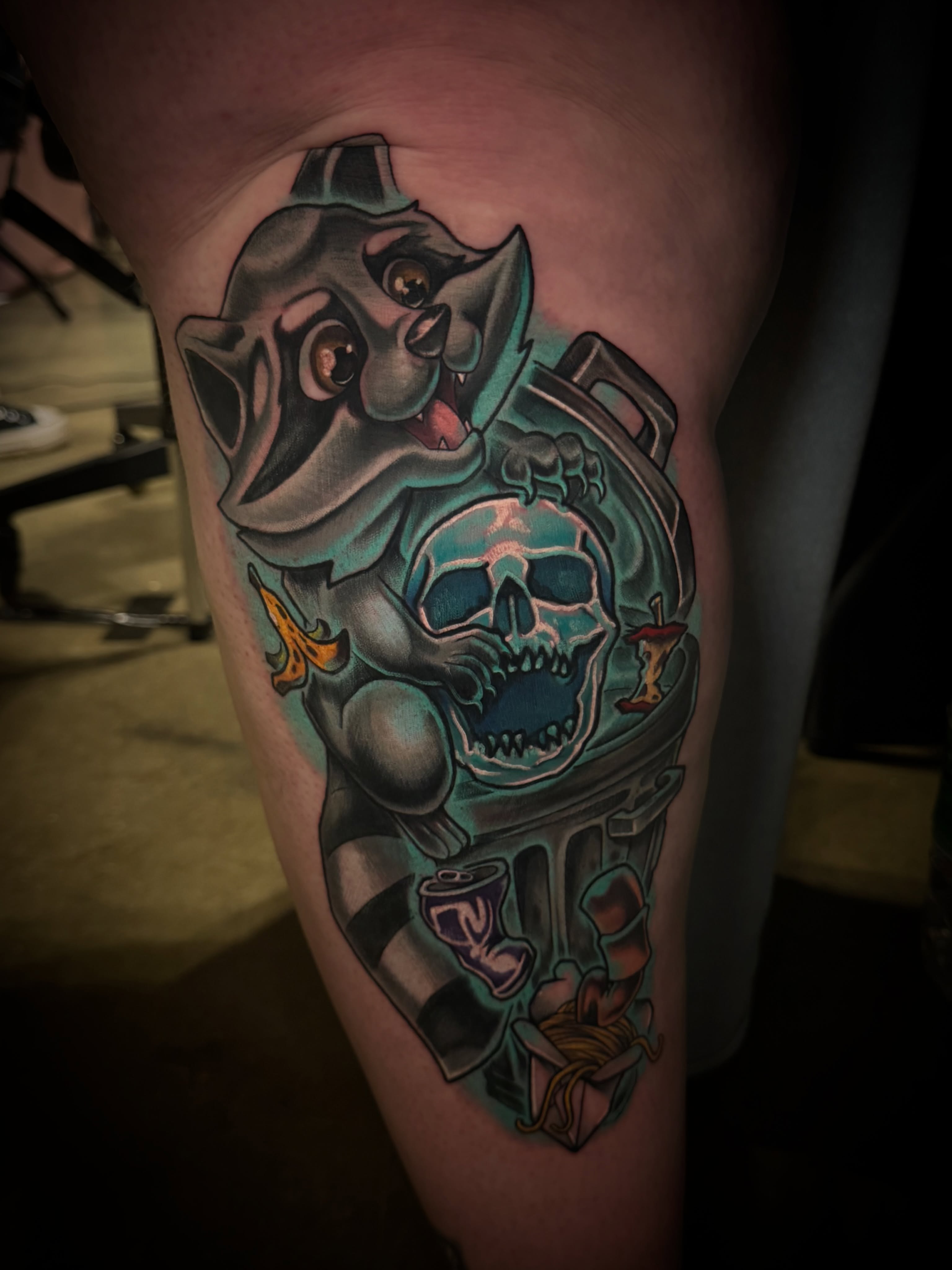 Skull and raccoon American traditional tattoo on the thigh by Tyler Jewett