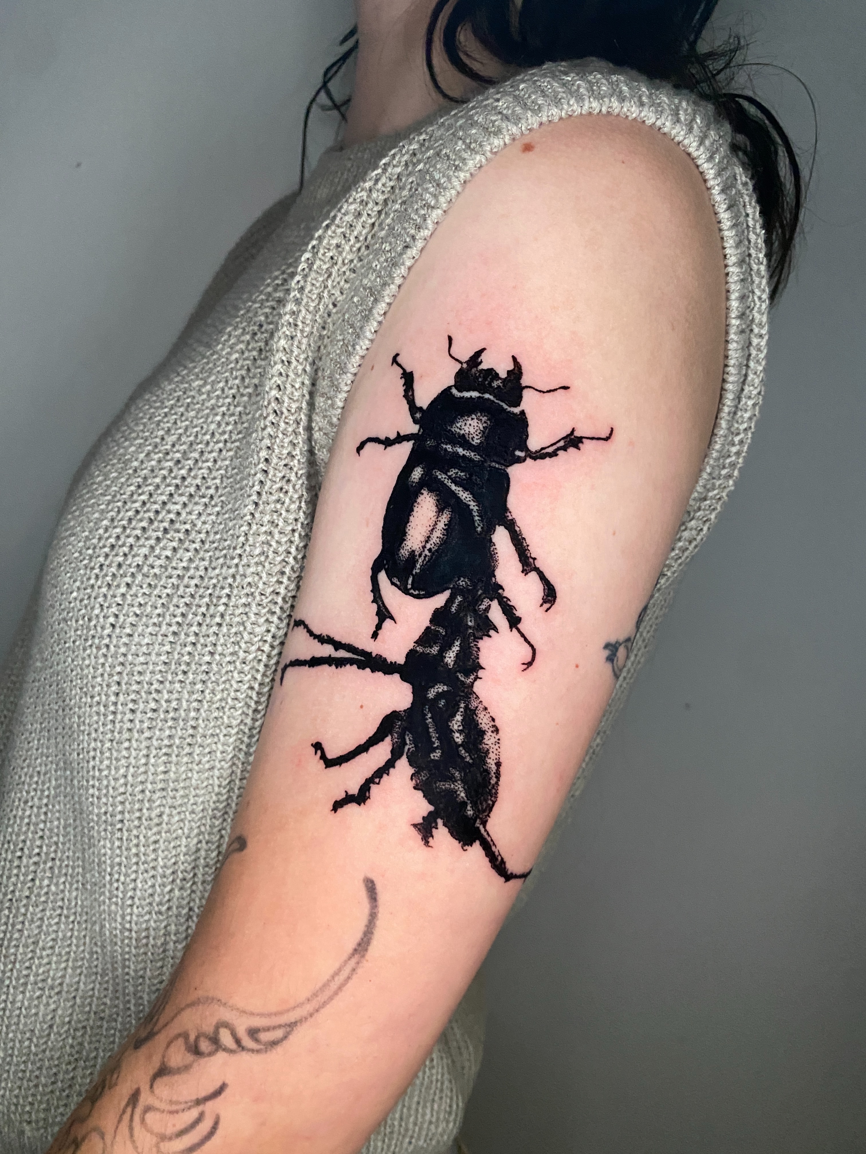 Beetle black and grey tattoo on the forearm by Aidan Leery, Portland, Oregon