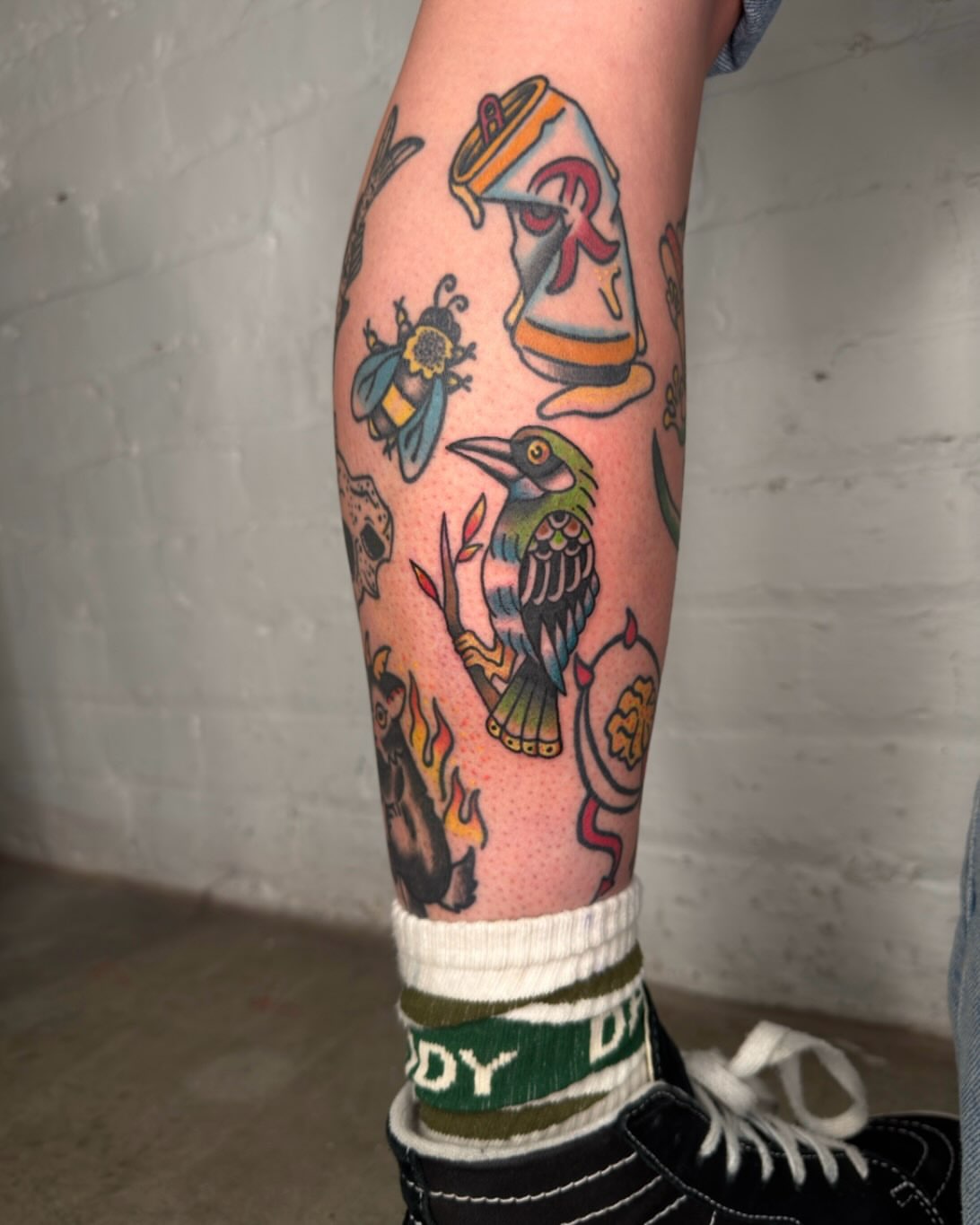 Bird and bee American traditional tattoo on the forearm by Dennis Patterson