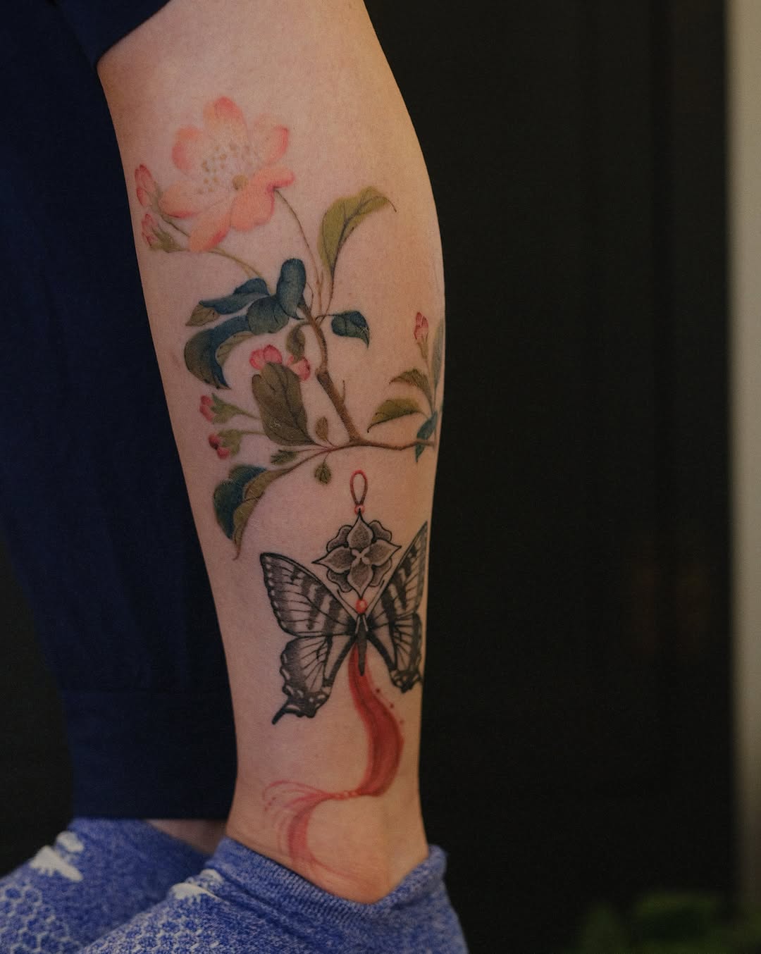 Butterfly and flowers watercolor tattoo on the forearm by Temple Adorned Tattoo
