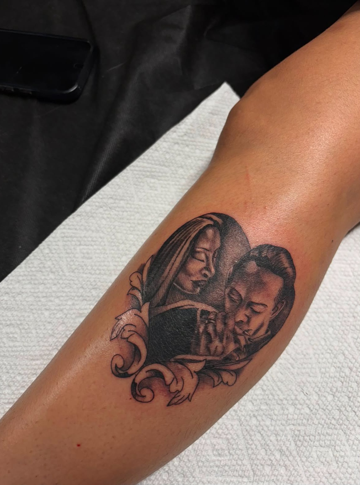 Couple praying realism tattoo on the forearm by suzie