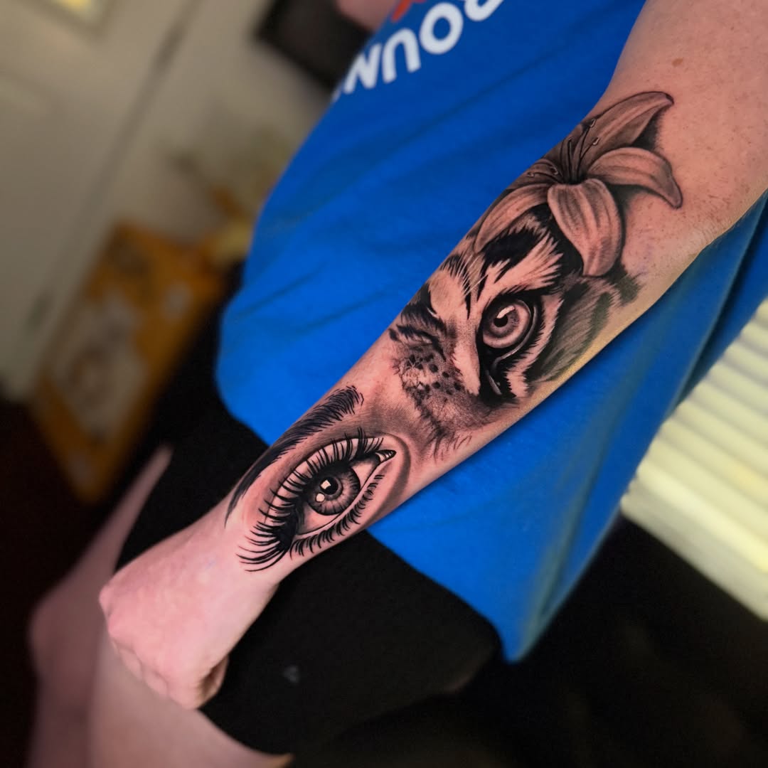 Eye and tiger realism tattoo on the forearm by Quentin Stevenson, Slidell, Louisiana