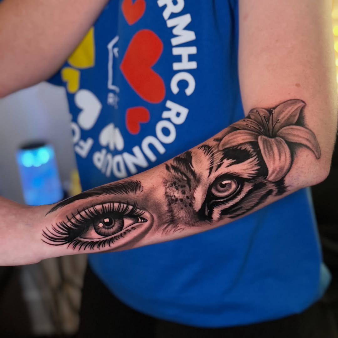 Eye and tiger realism tattoo on the forearm by Quentin Stevenson, Slidell, Louisiana
